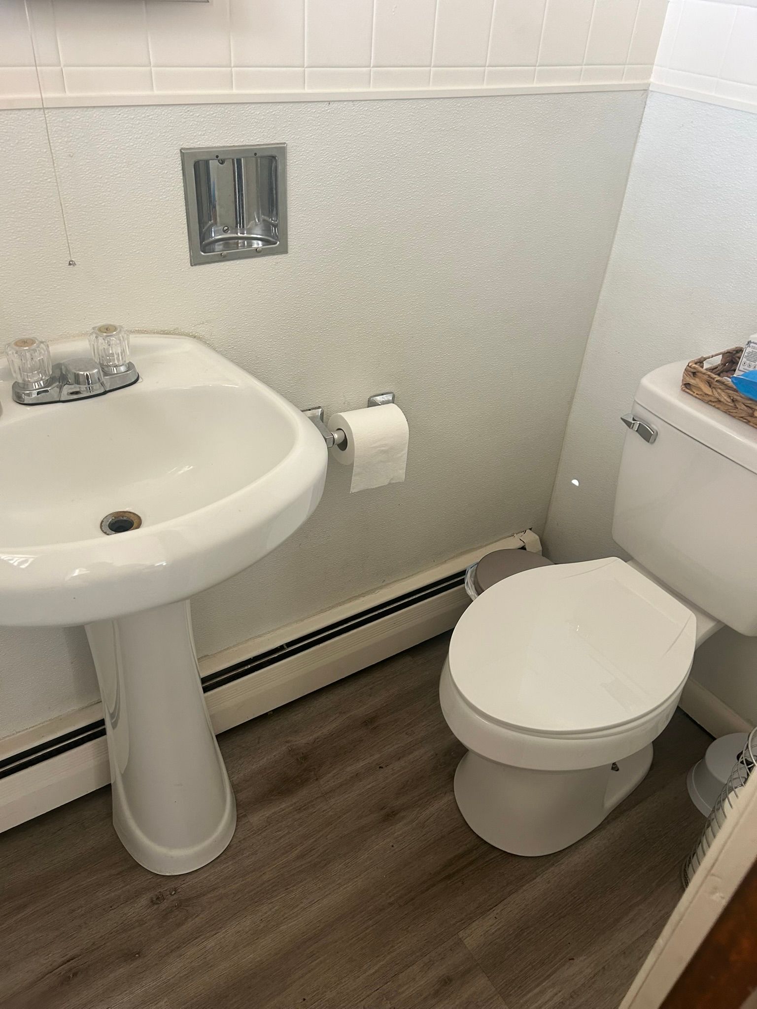 A bathroom with a sink and toilet in it.