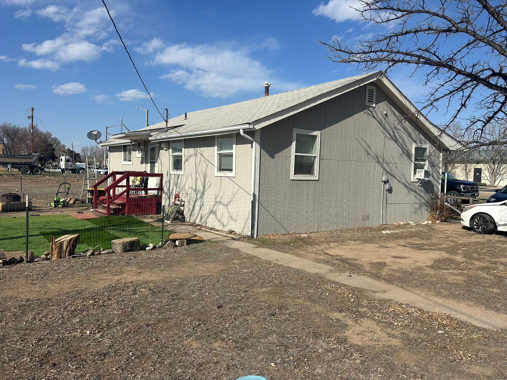 A house with a car parked in front of it.