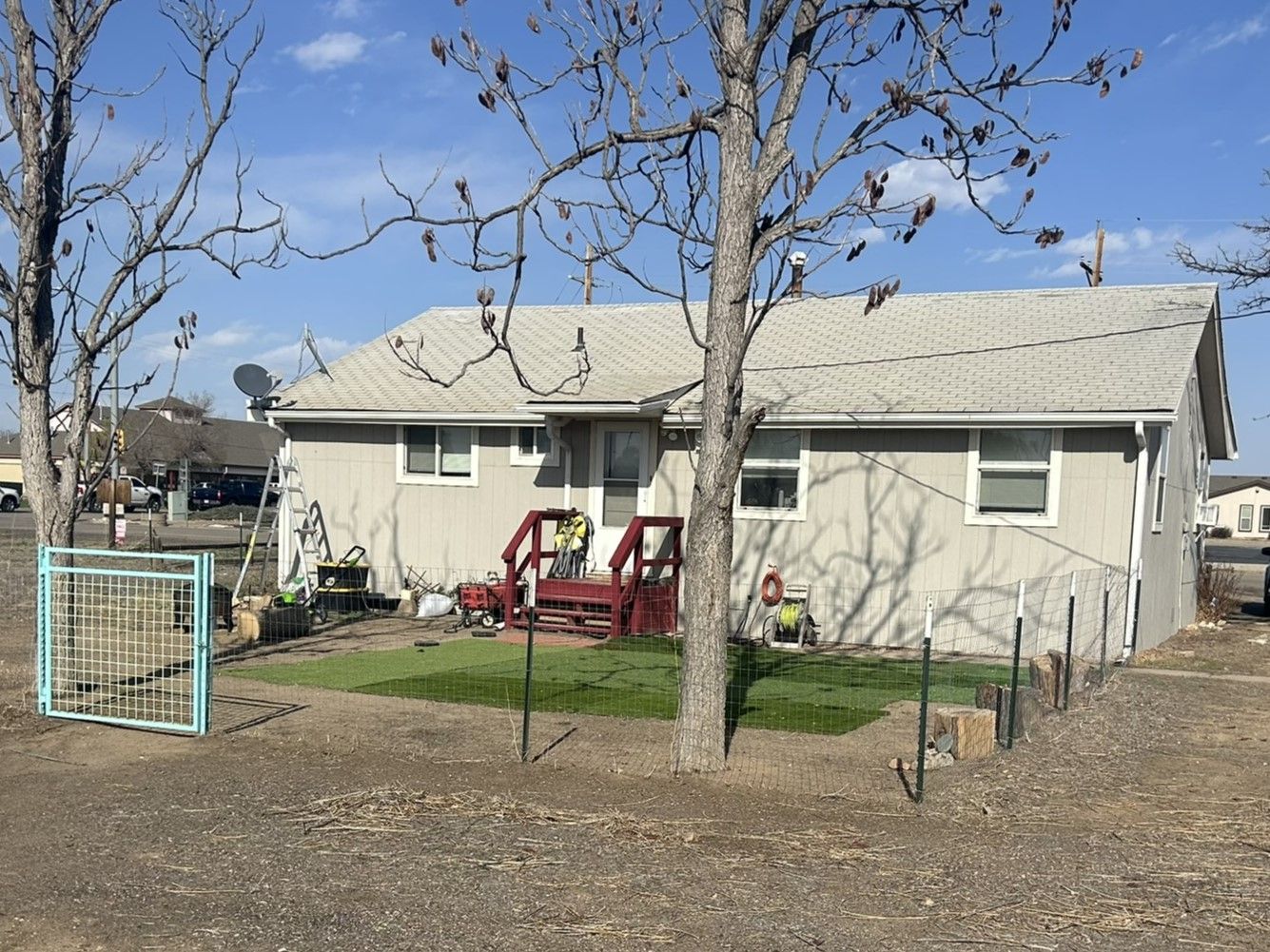 A small house with a playground in front of it.