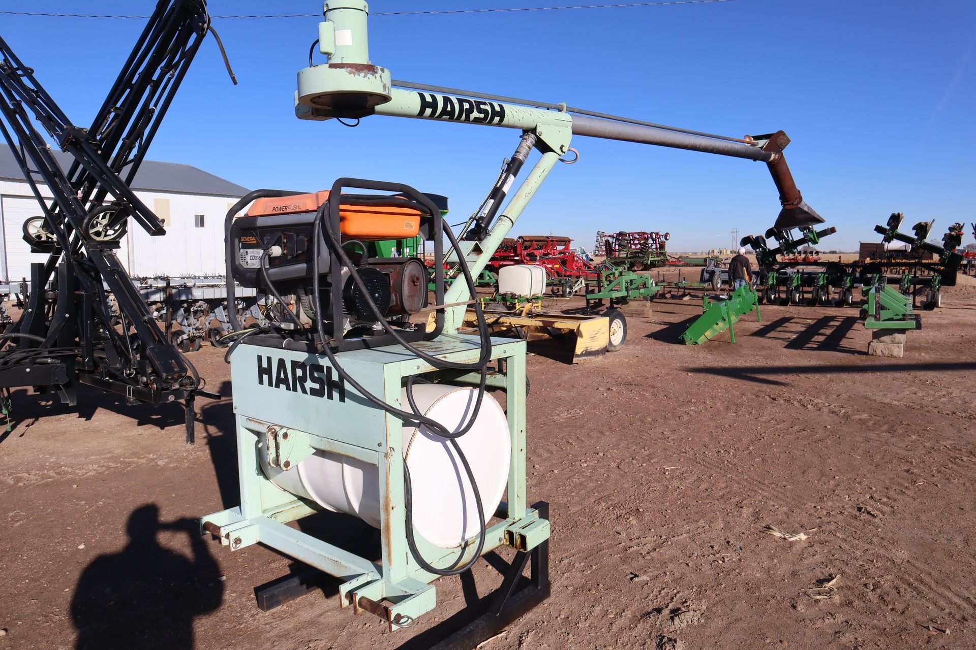 A harsh machine is sitting in a dirt field