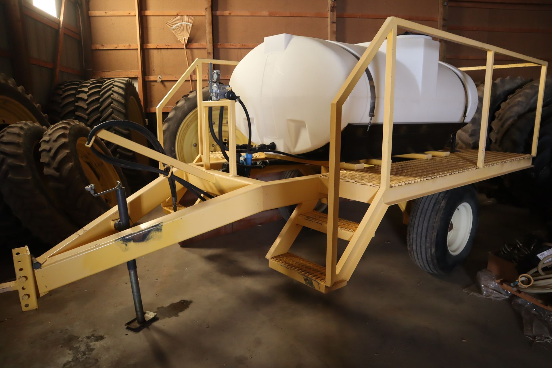 A yellow trailer with a white tank on it