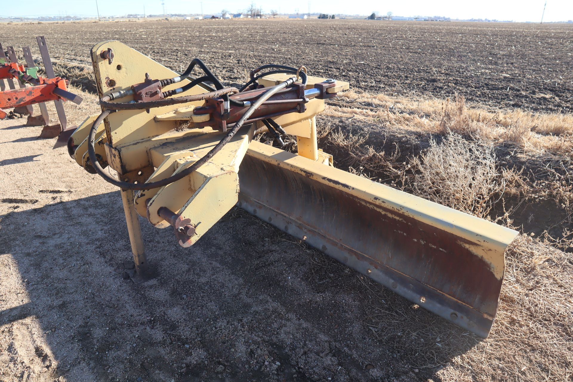 A bulldozer is parked in the middle of a field