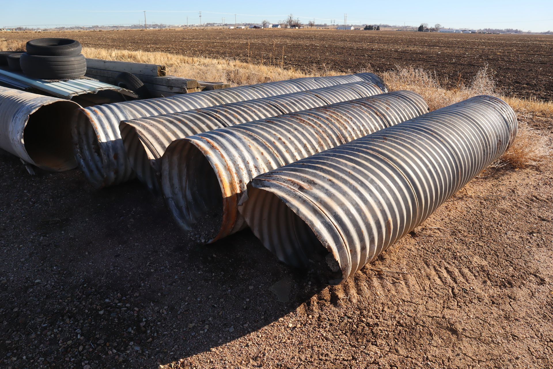 A bunch of metal pipes are laying on the ground