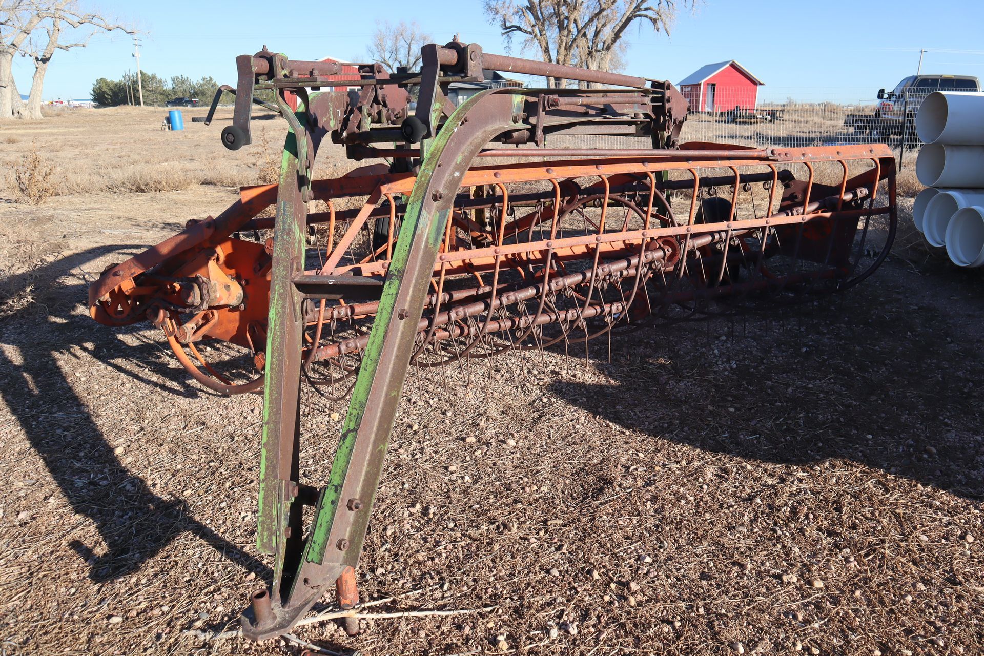 An old rusty tractor is sitting on the ground in a field