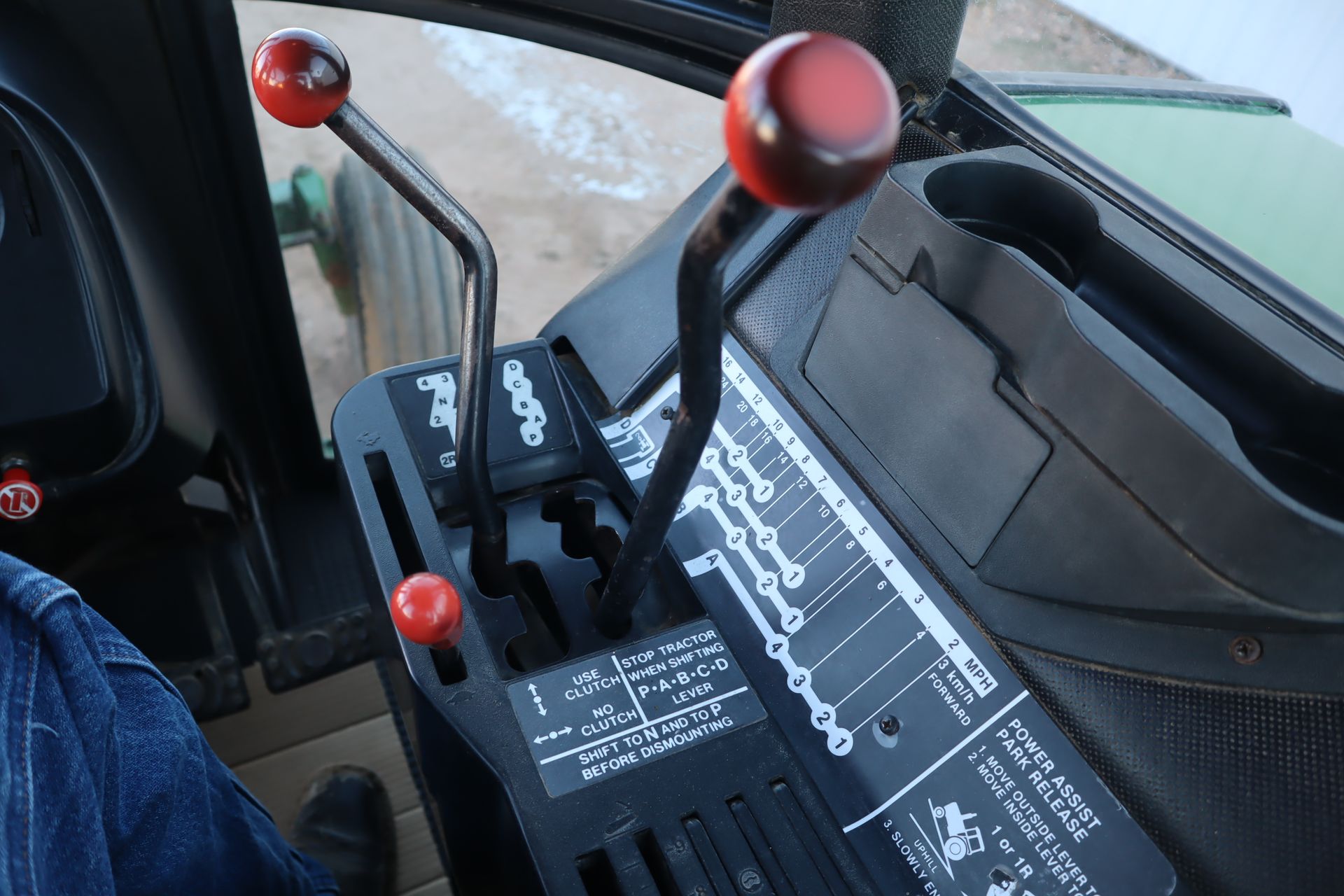 A person is sitting in the driver 's seat of a tractor