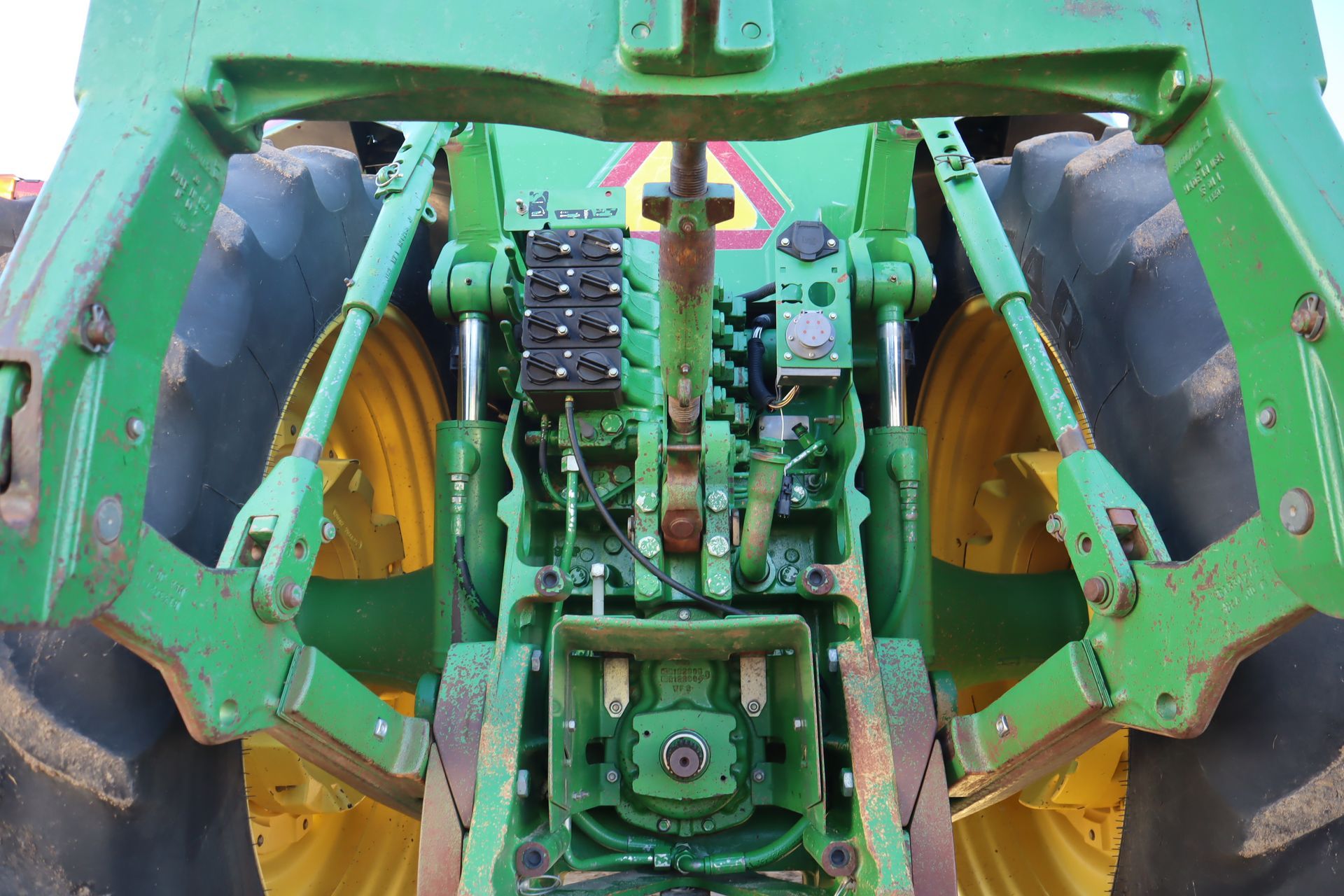 A close up of a green and yellow tractor