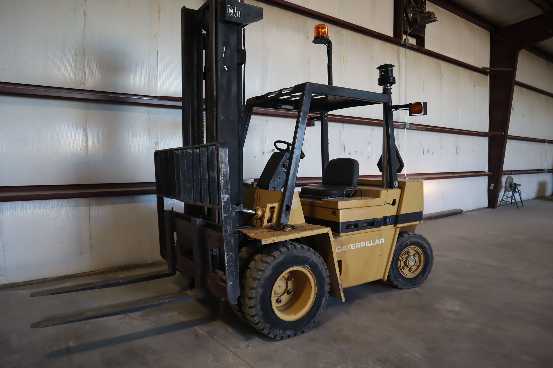 A yellow forklift is parked in a warehouse.