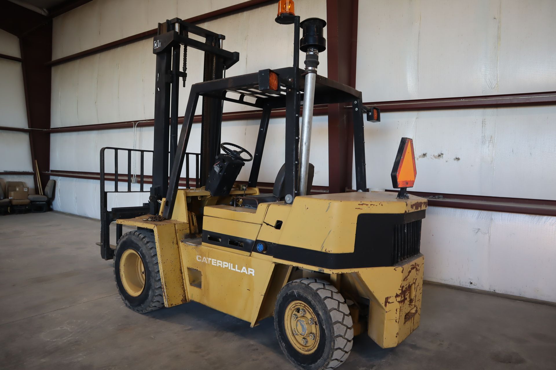 A yellow forklift is parked in a warehouse.