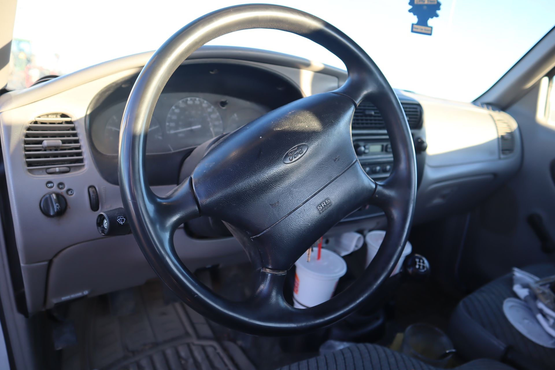 A close up of a steering wheel in a car