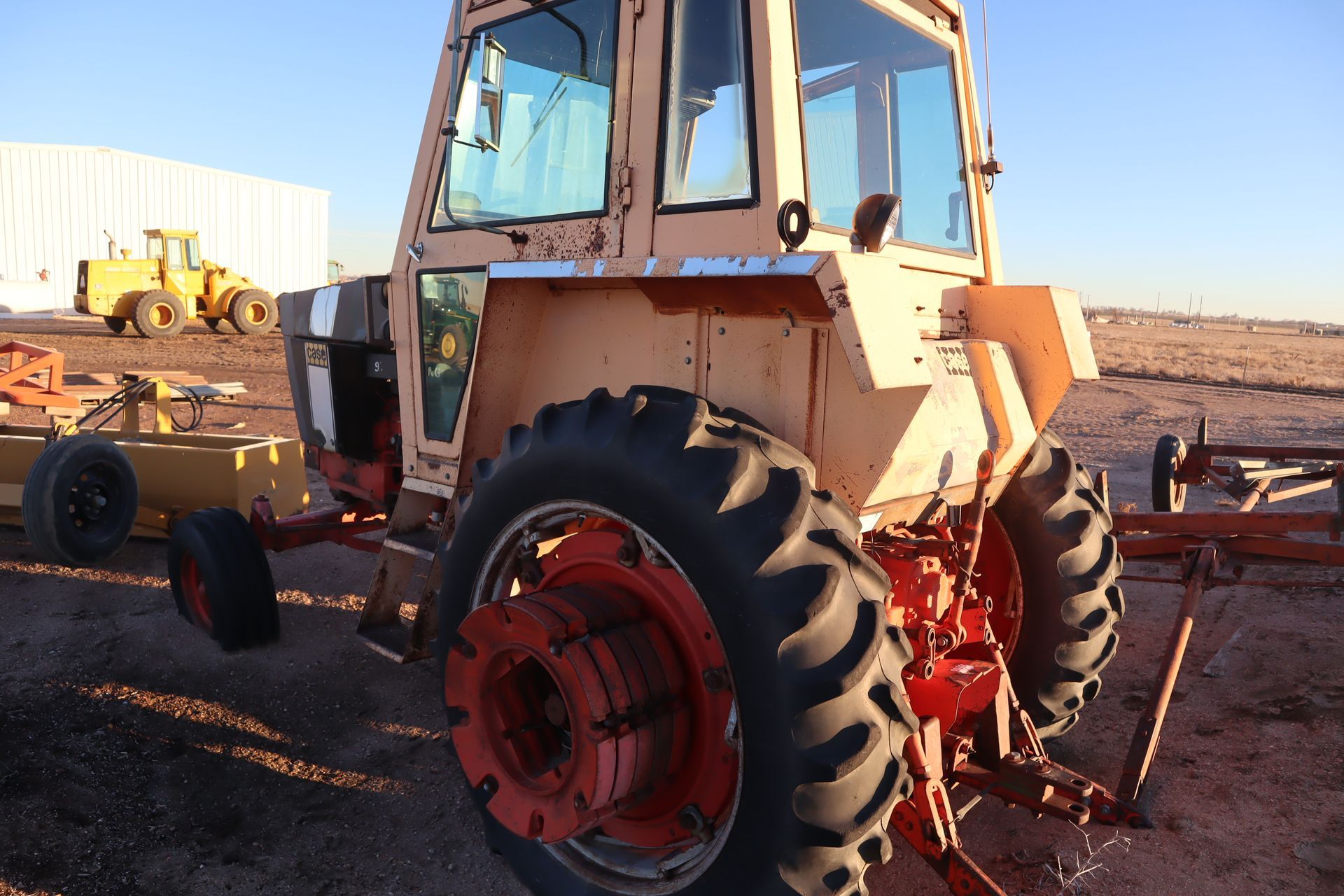A tractor is parked in a field with other tractors
