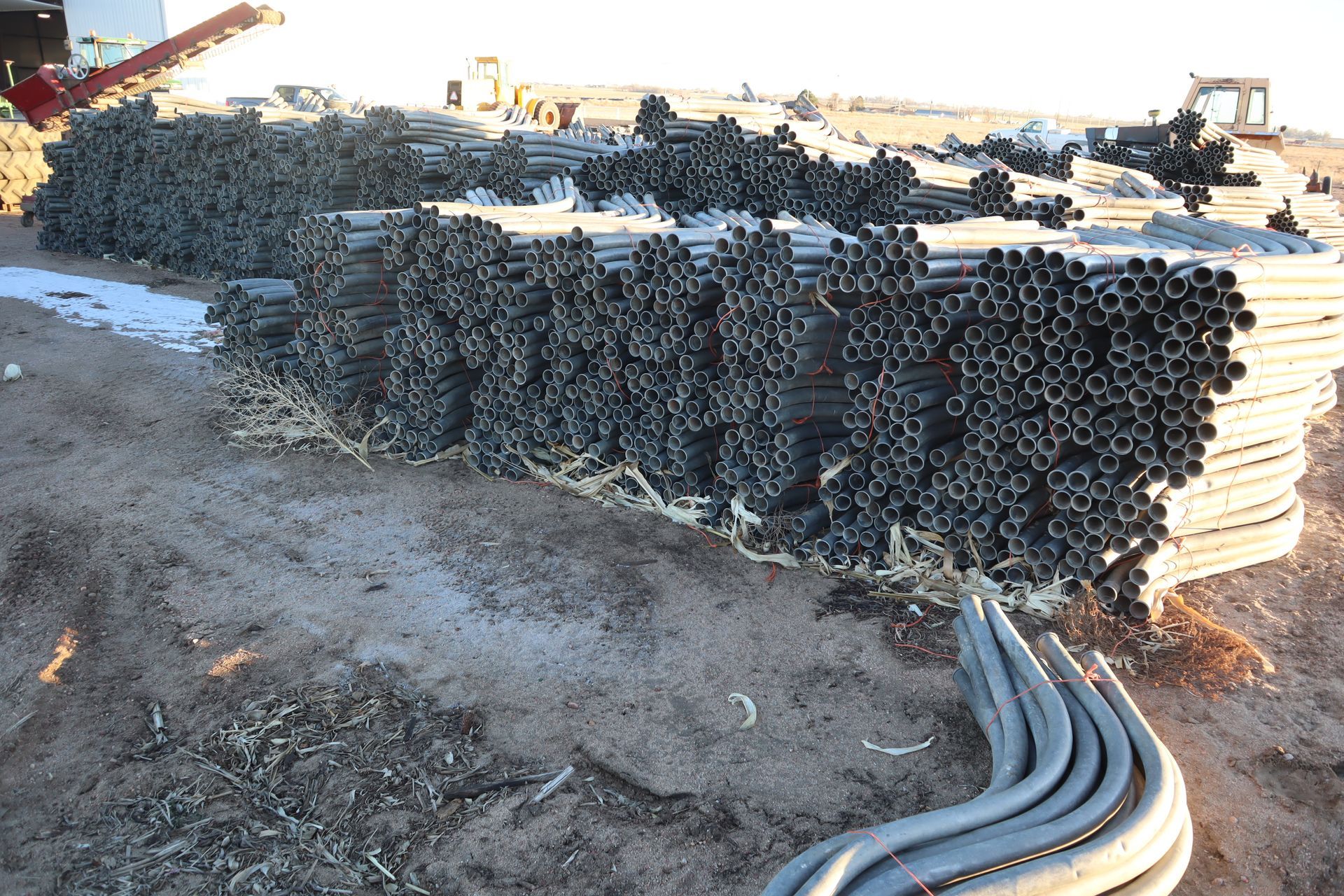 A bunch of pipes are stacked on top of each other