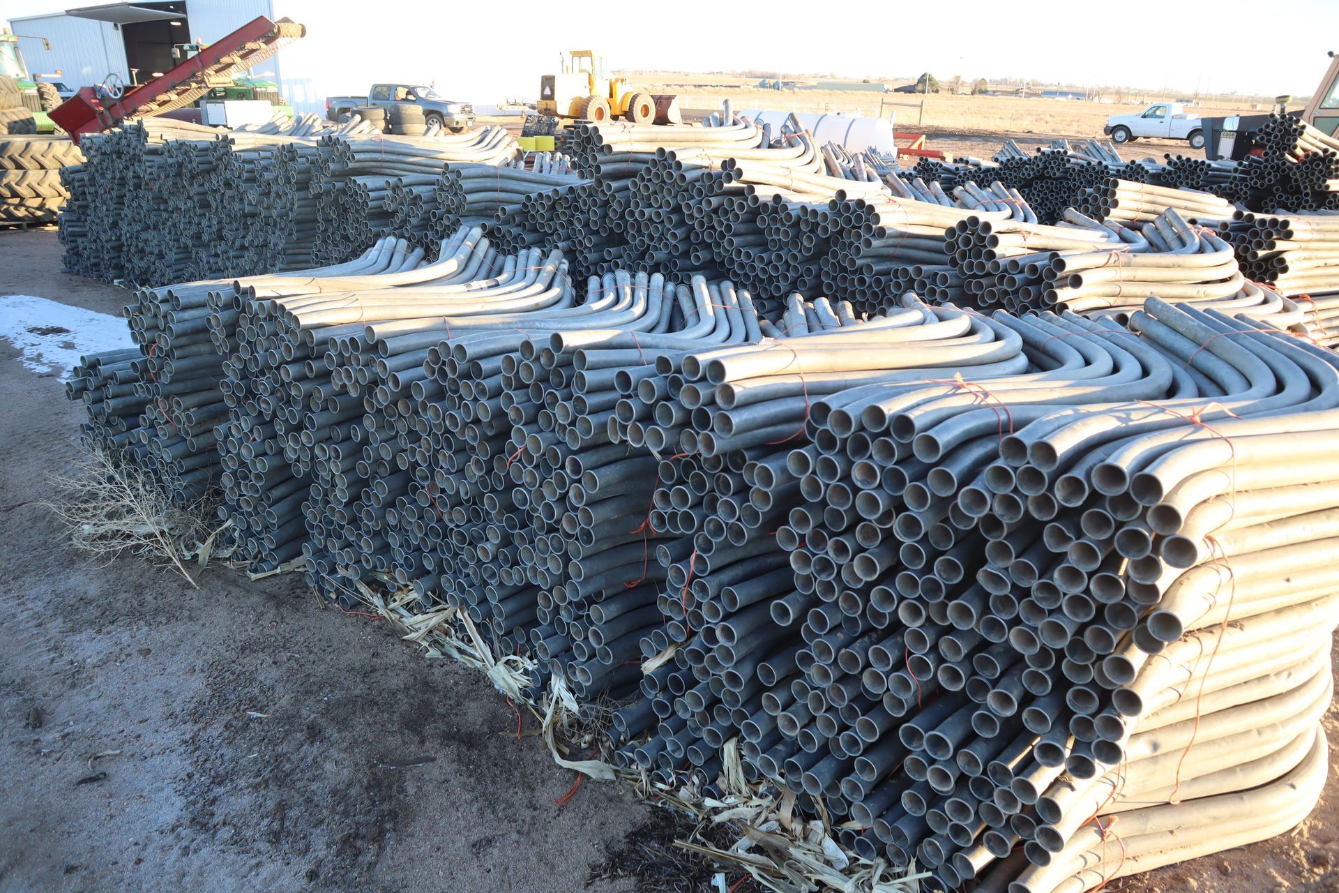 A bunch of pipes are stacked on top of each other