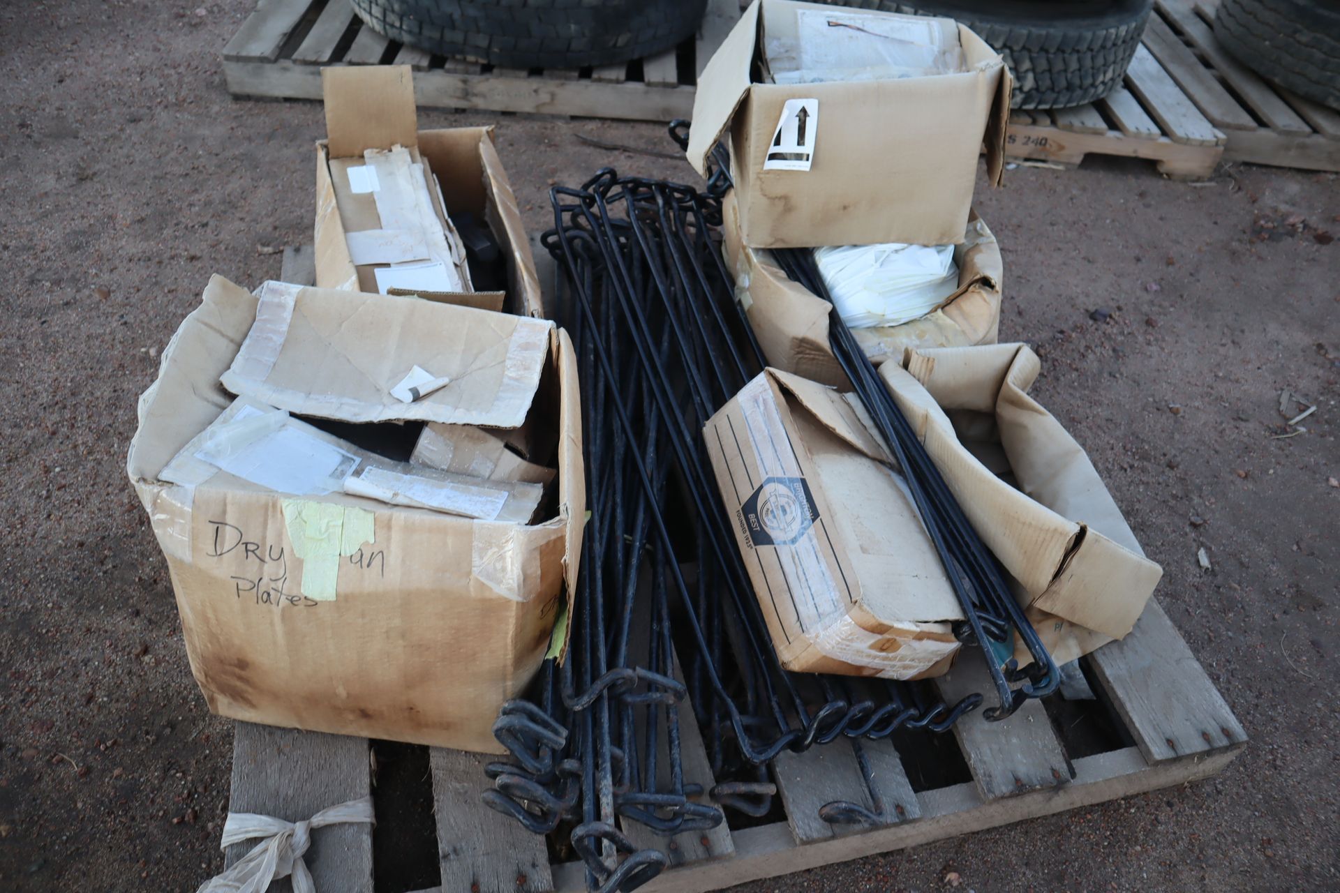 A bunch of boxes are sitting on a wooden pallet