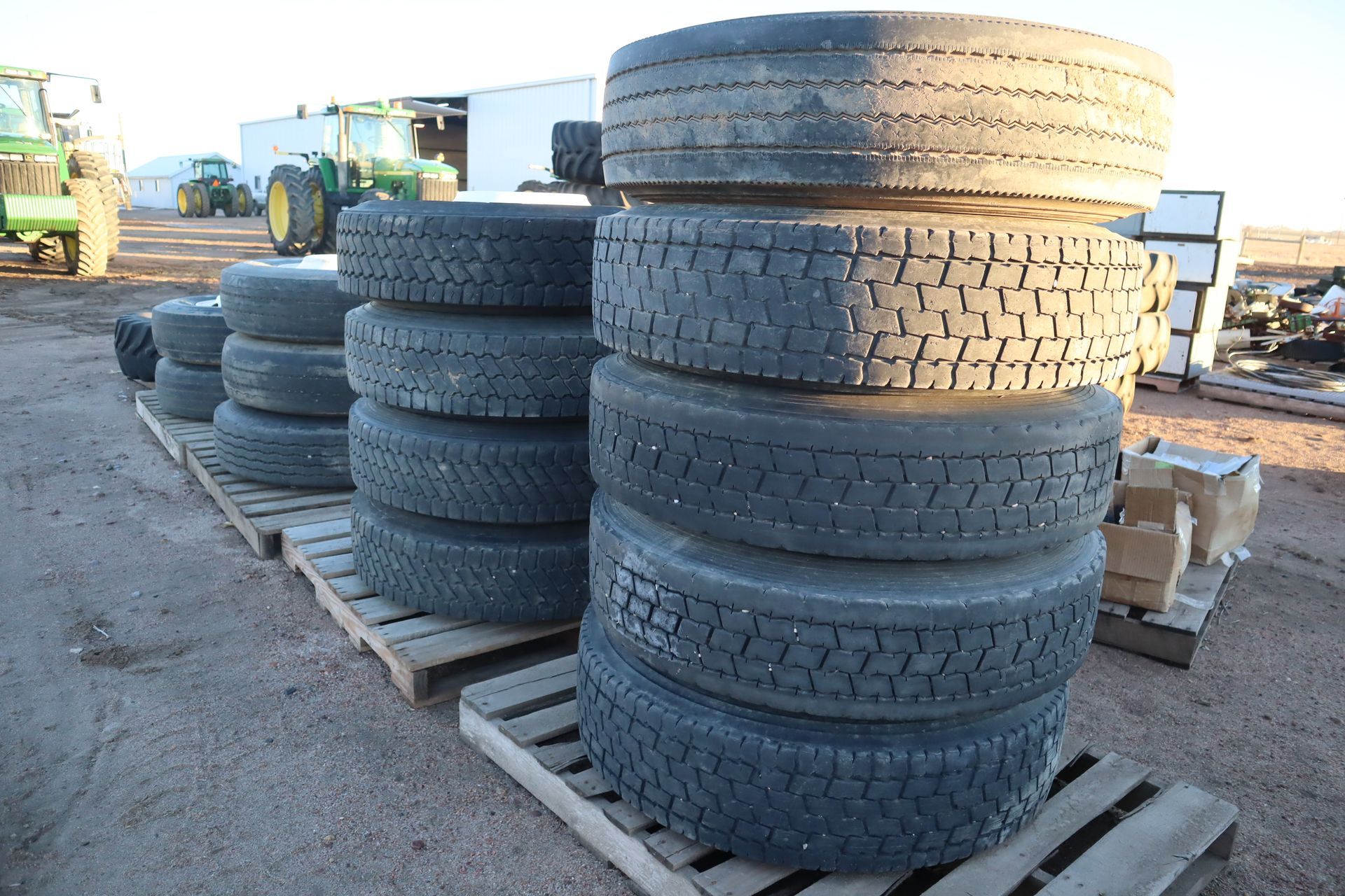 A stack of tires sits on a wooden pallet