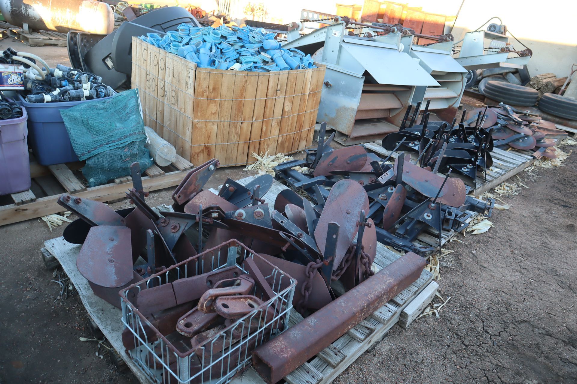 A pile of scrap metal is sitting on a wooden pallet