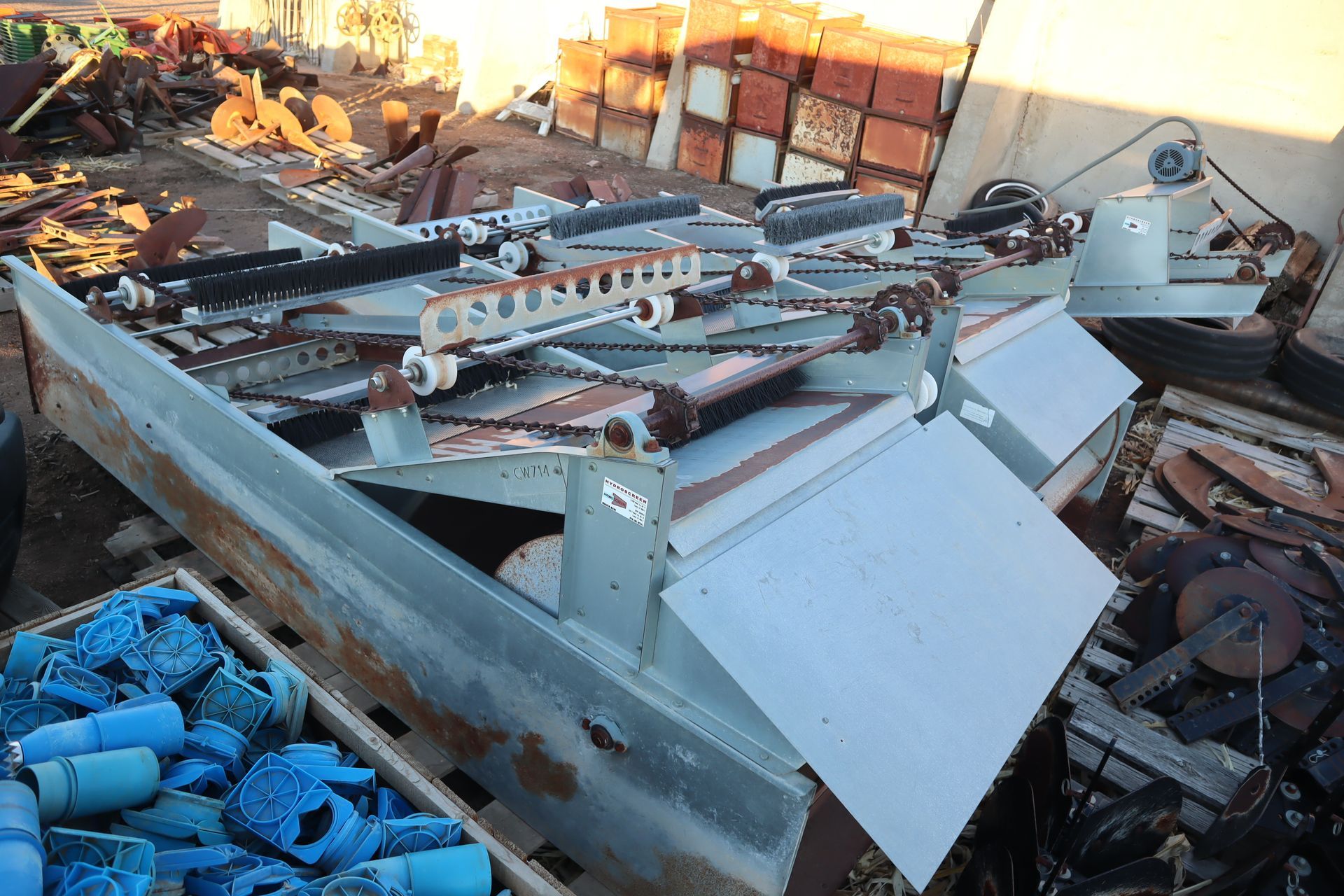 A pile of scrap metal is sitting on top of a wooden pallet.