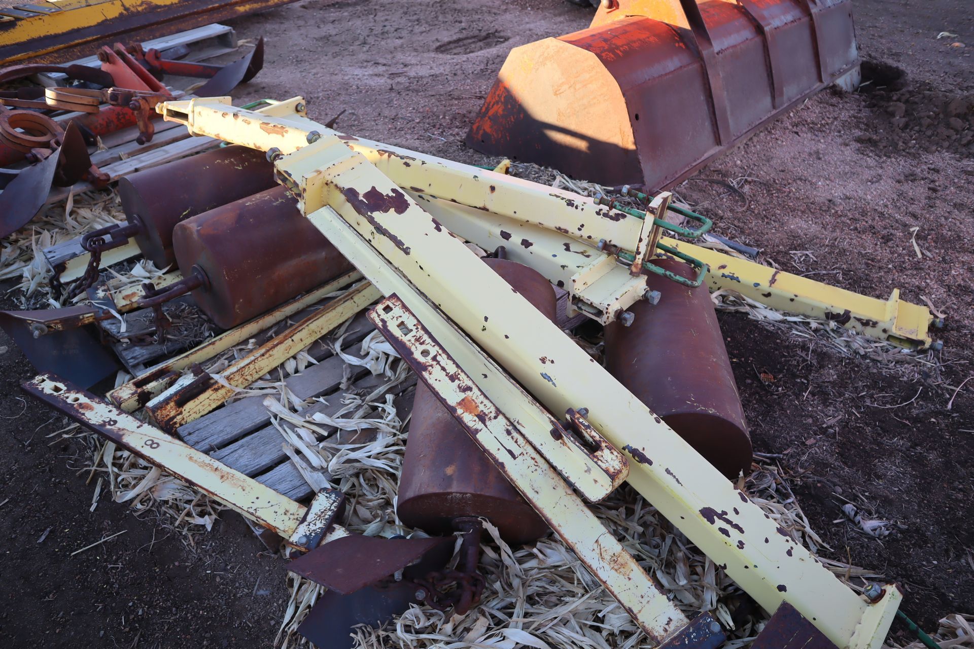 A pile of rusty metal is laying on the ground