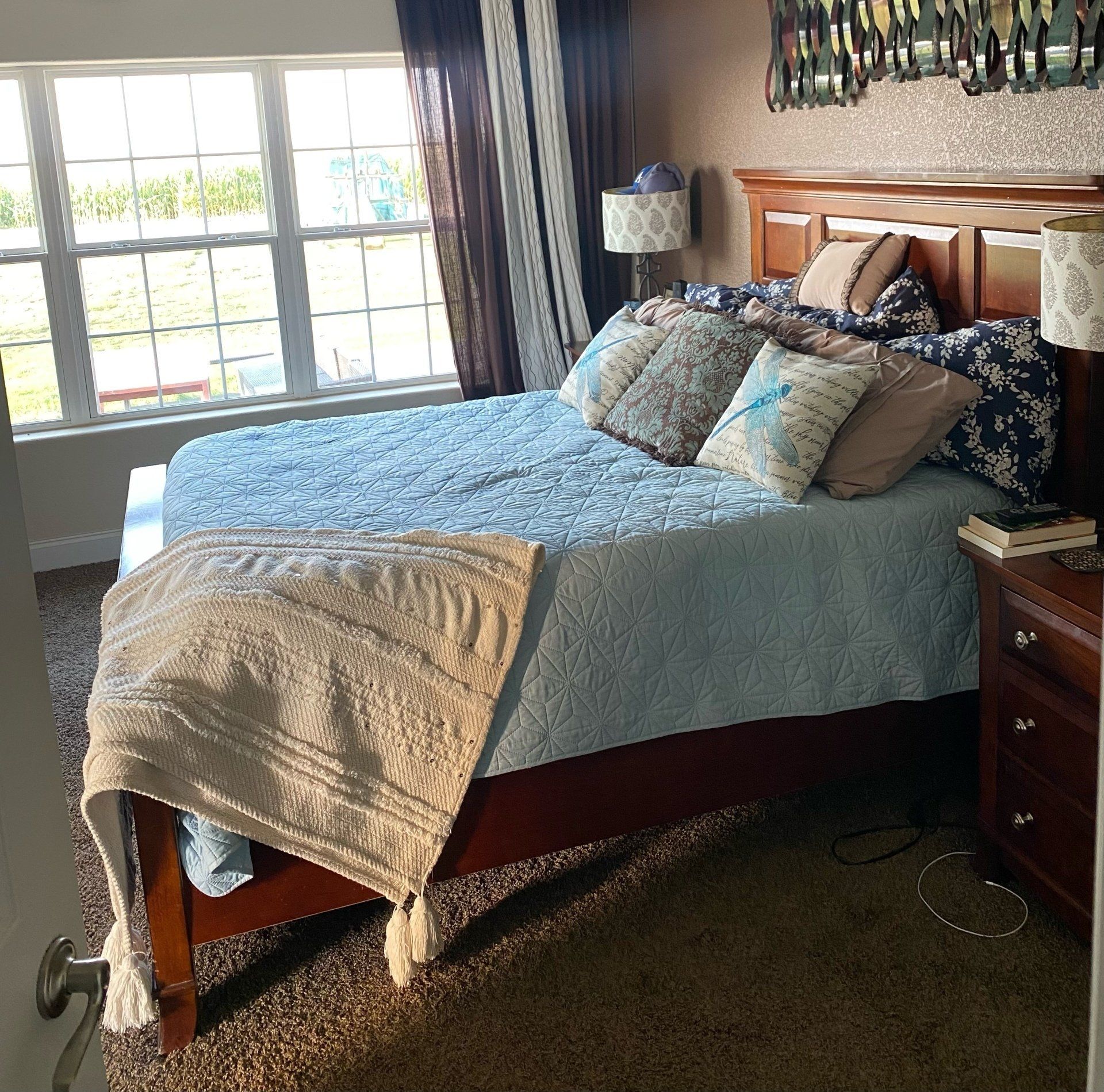 A bedroom with a large bed and a window