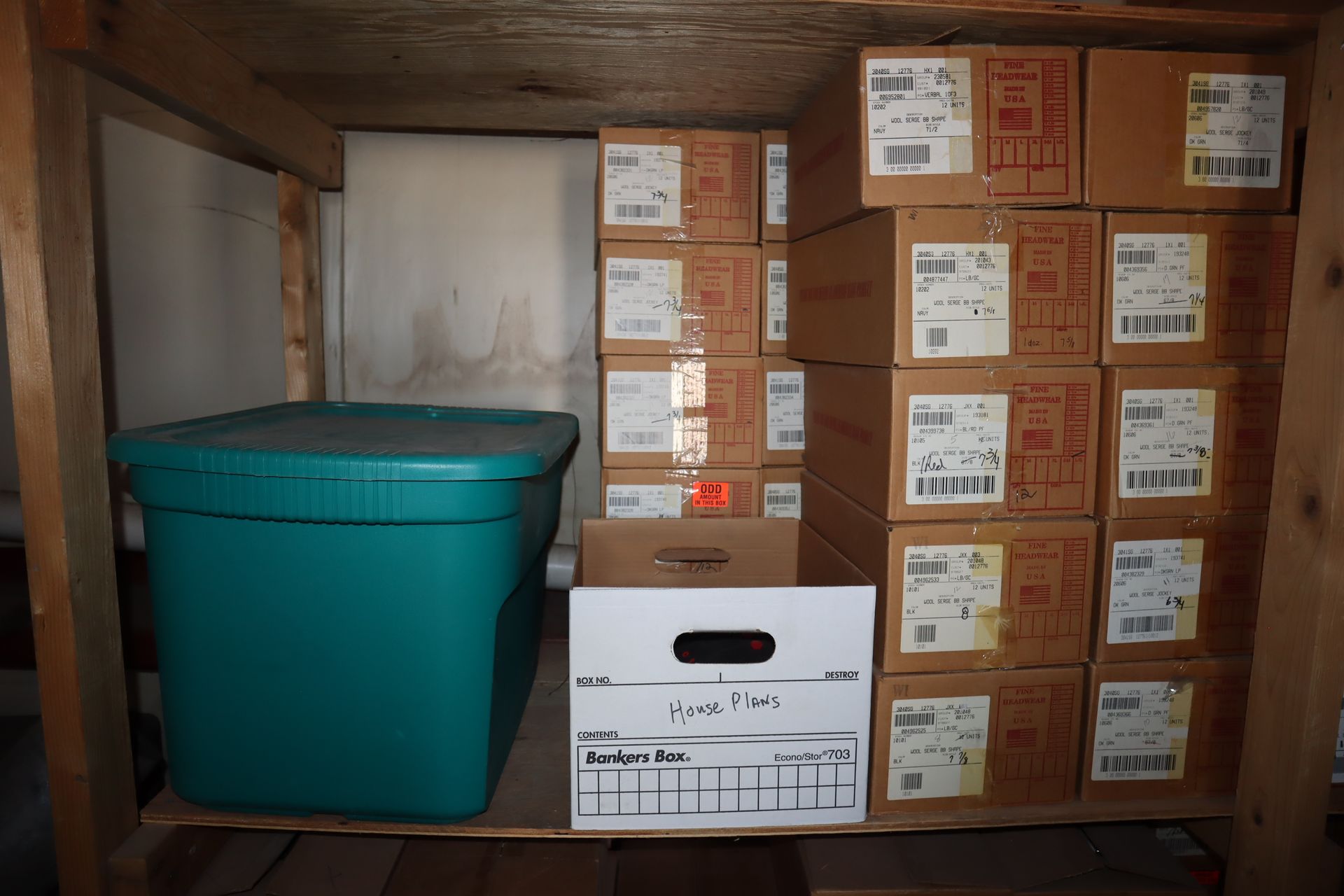 Wooden shelf with boxes and a turquoise bin; indoors.