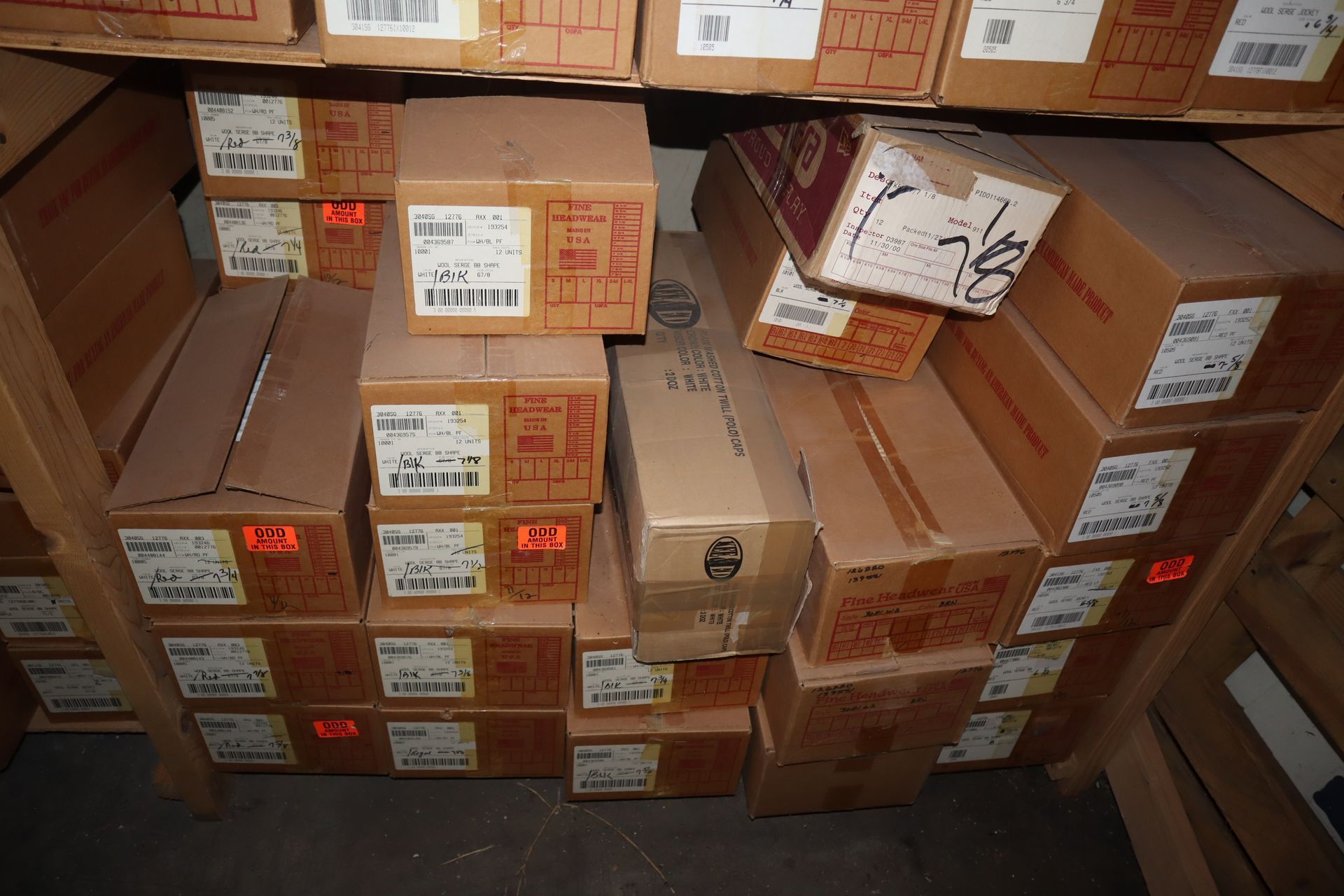 Boxes stacked on shelves, likely in a storage area, with labels visible on some.