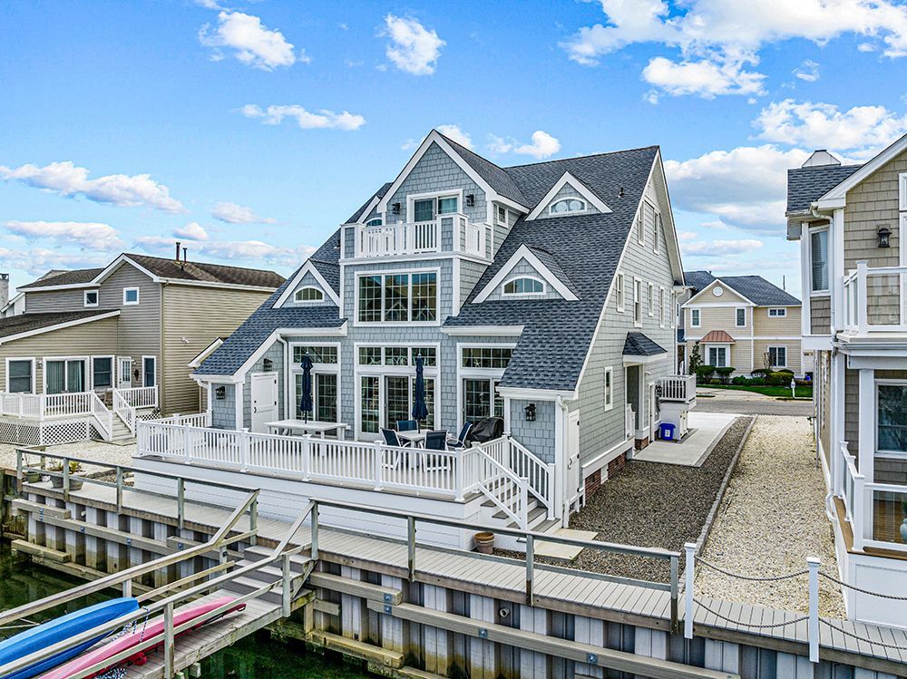 an aerial view of a large house next to a body of water