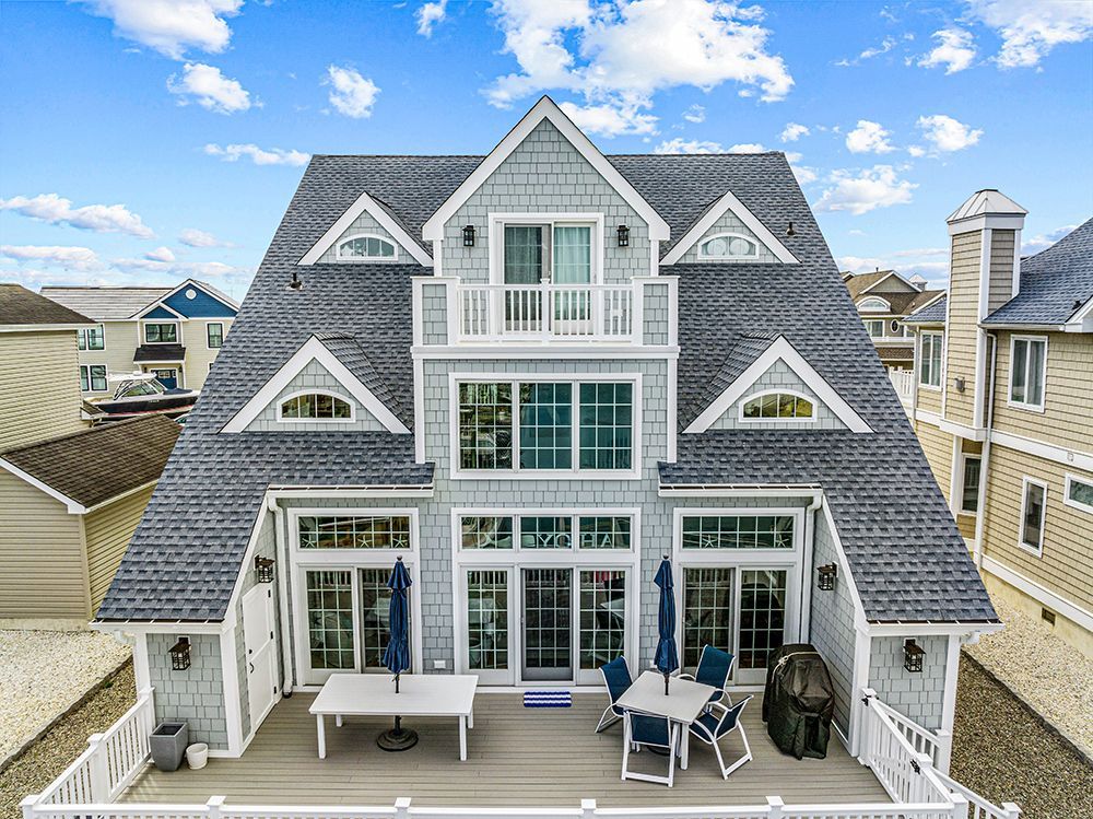 an aerial view of a large house with a large deck