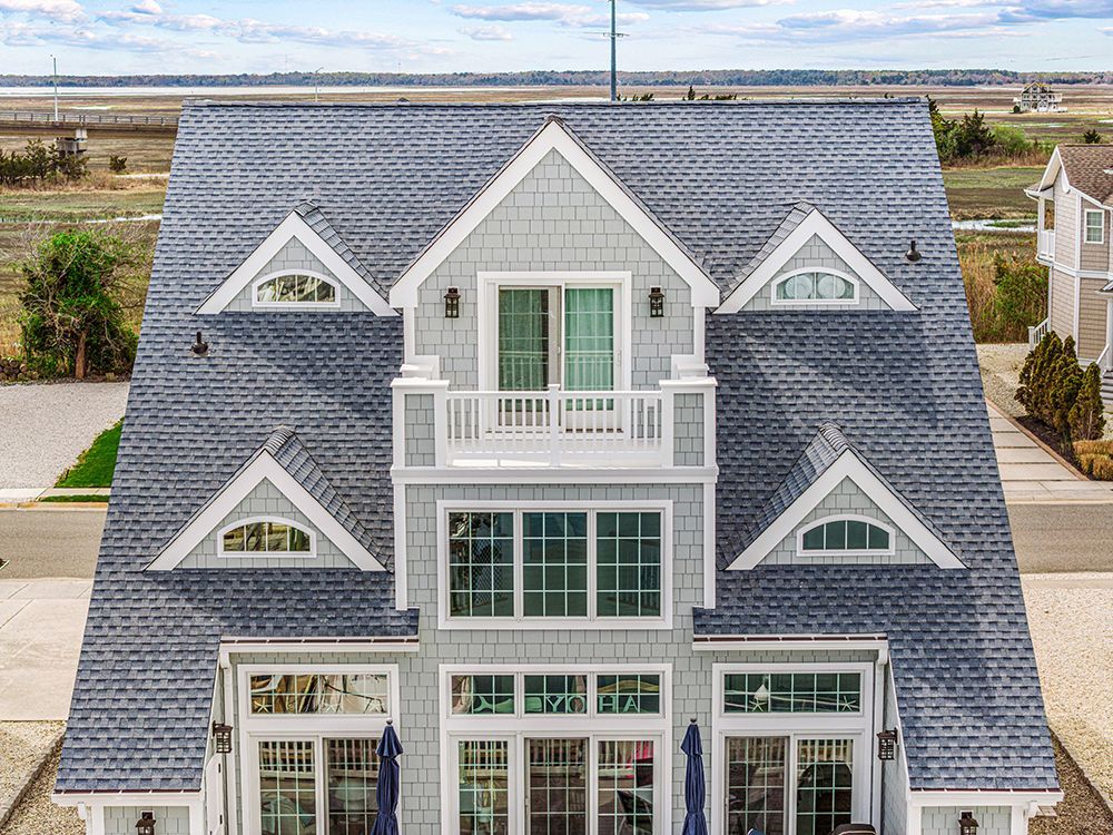 an aerial view of a large house with a blue roof