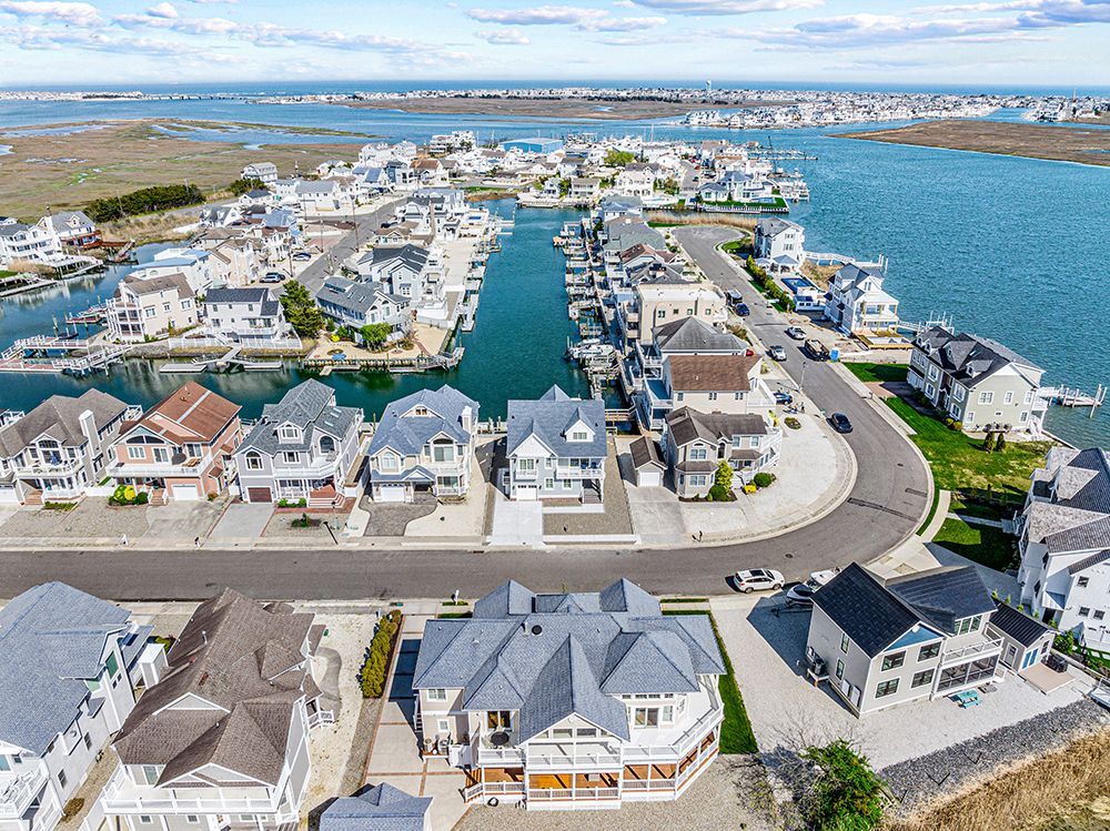 An aerial view of a residential area next to a body of water.