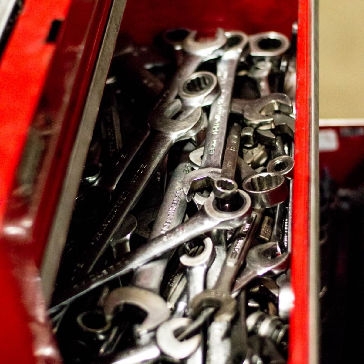 Red toolbox filled with various wrenches.