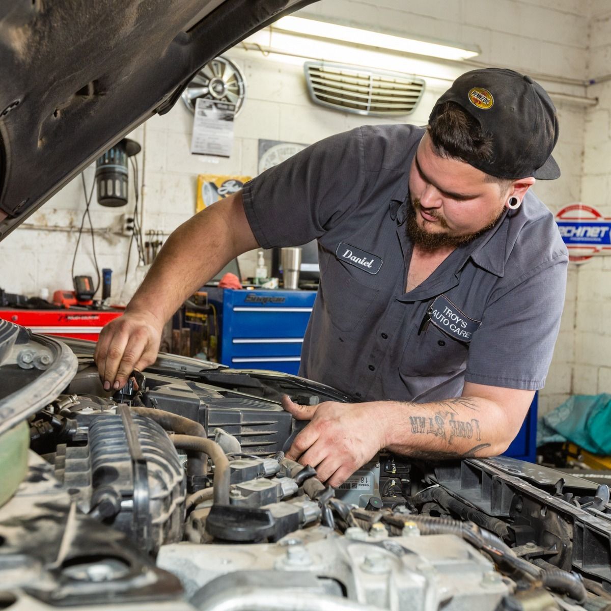Red classic Mini Cooper car with Christmas wreath and lights.