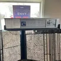 Tile display in a showroom, showcasing various textures and patterns.
