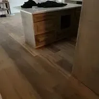 Wooden floor and kitchen island with open storage.