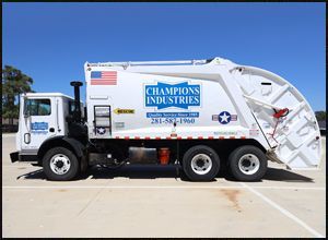 A garbage truck from Champions Industries is parked