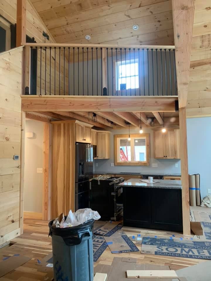 A kitchen with a trash can in the middle of it.