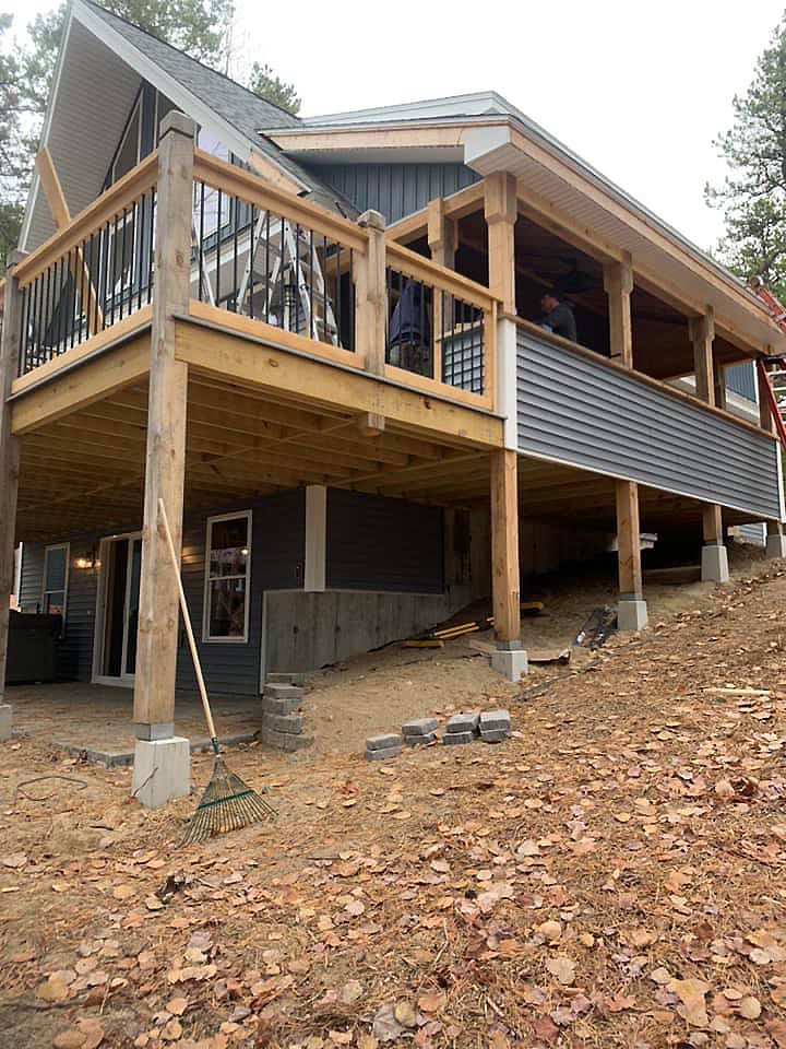 A house is being built on a hill with a large deck.
