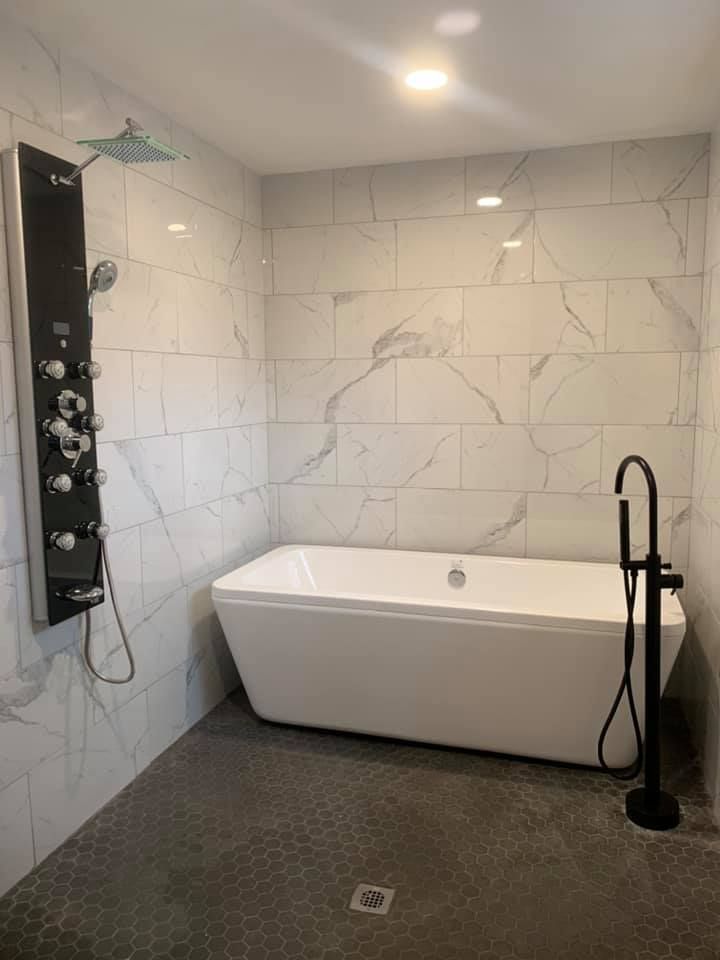 A bathroom with a bathtub and a shower.