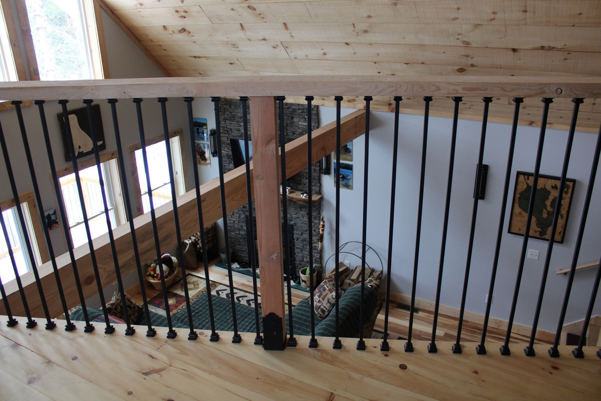 A wooden staircase with a wrought iron railing