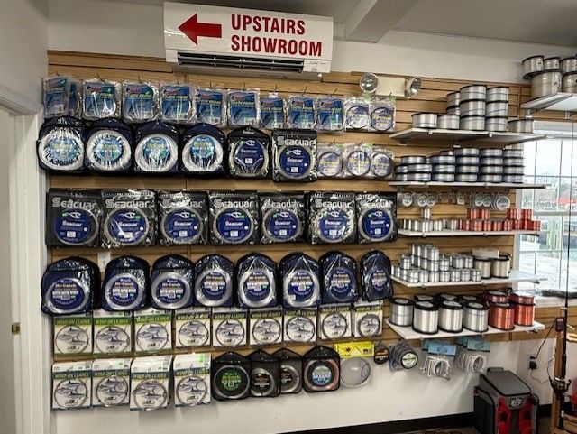 There is a sign that says upstairs showroom on the wall.