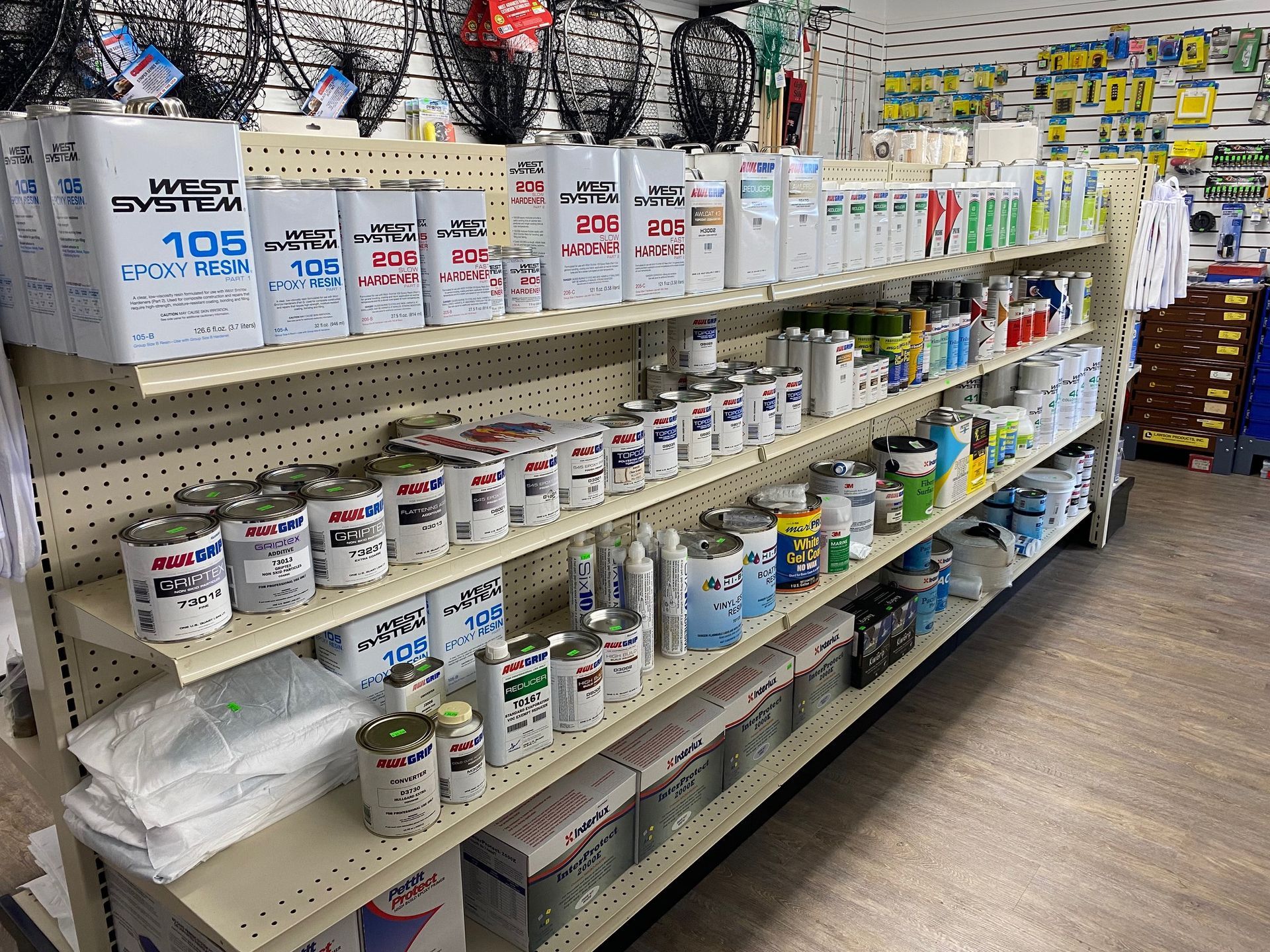 A store shelf filled with lots of cans of paint.