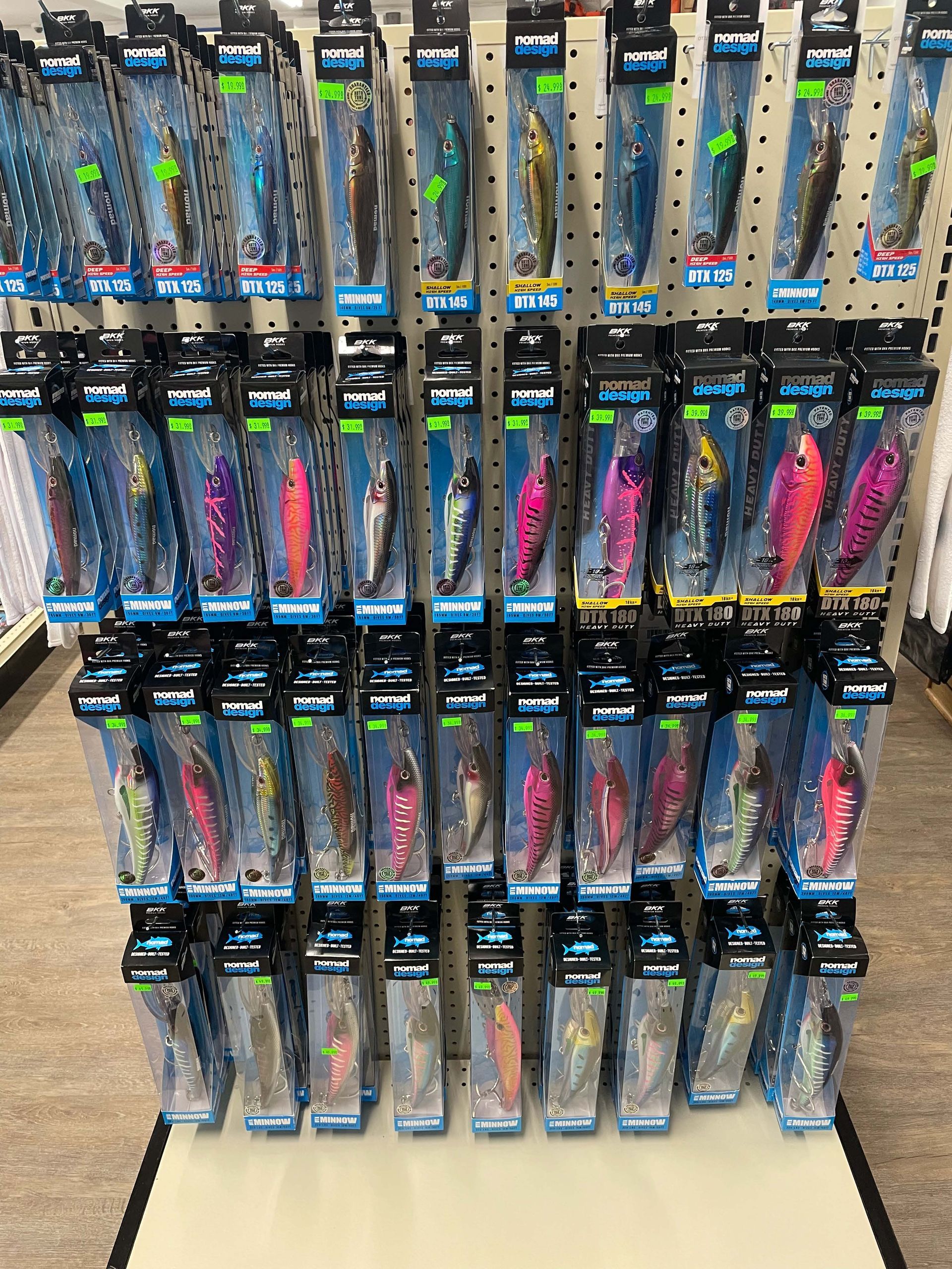 A display of fishing lures on a rack in a store.