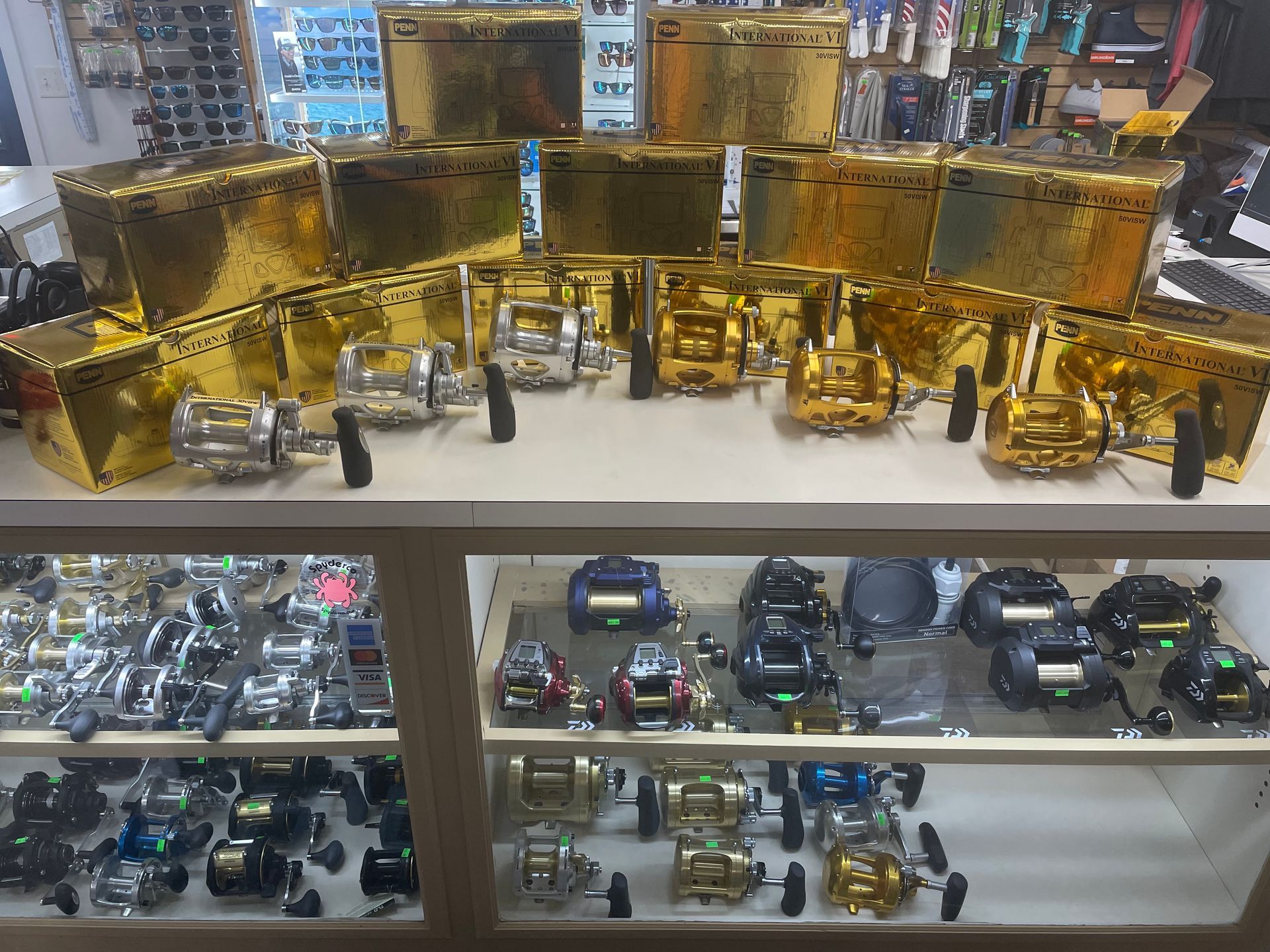 A display case filled with lots of fishing reels and boxes.