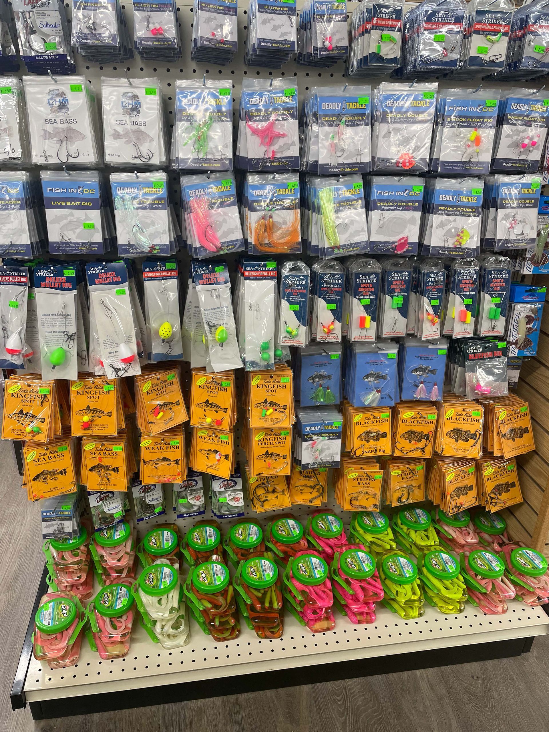 A shelf filled with lots of fishing lures in a store.