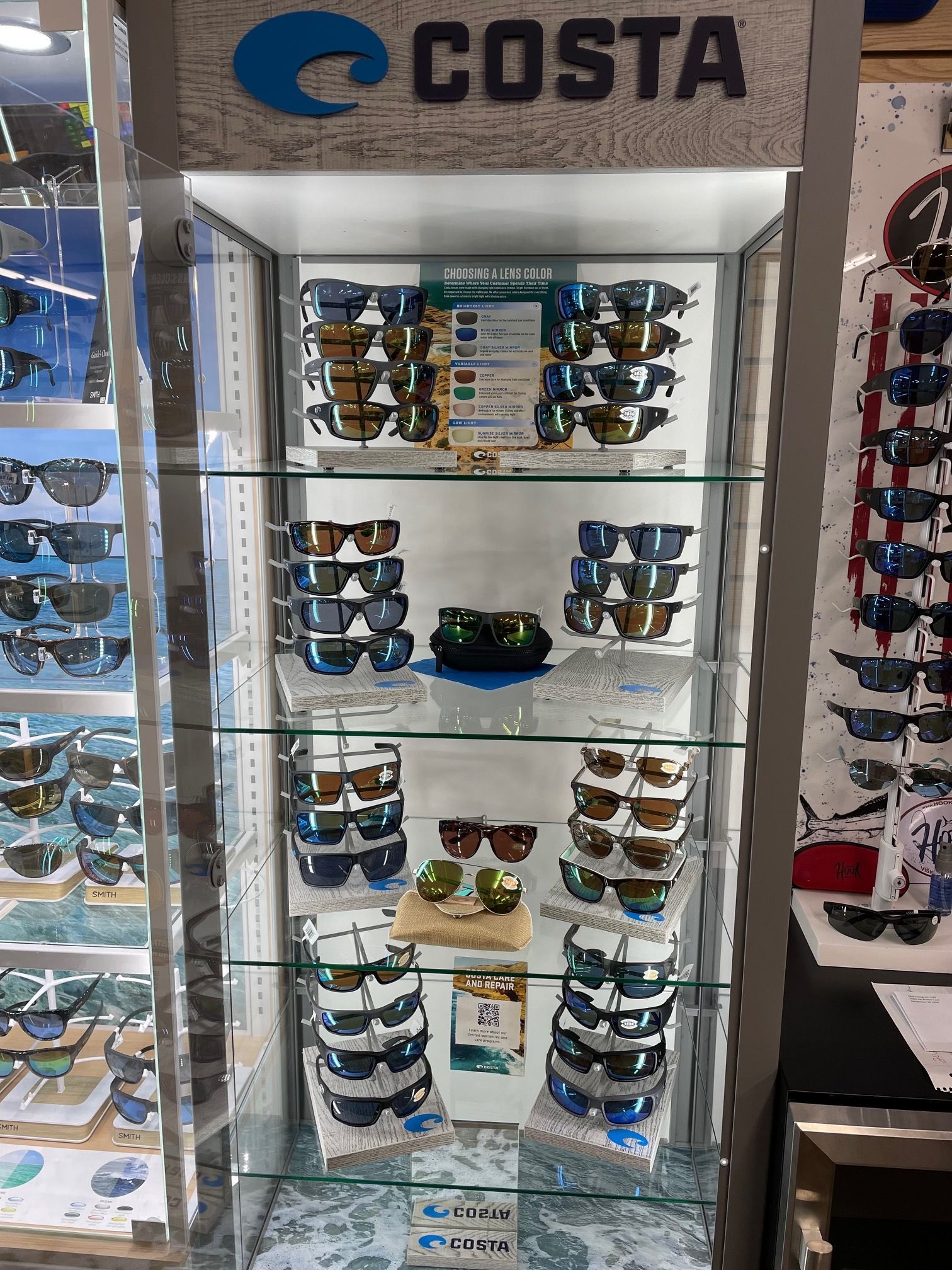 A display case filled with sunglasses in a store.