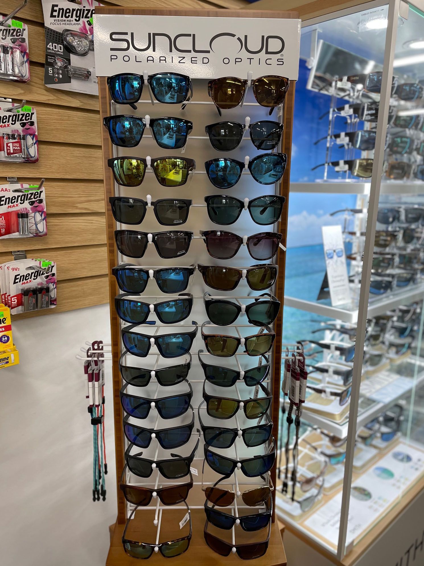 A display of sunglasses in a store with a sign that says suncloud.