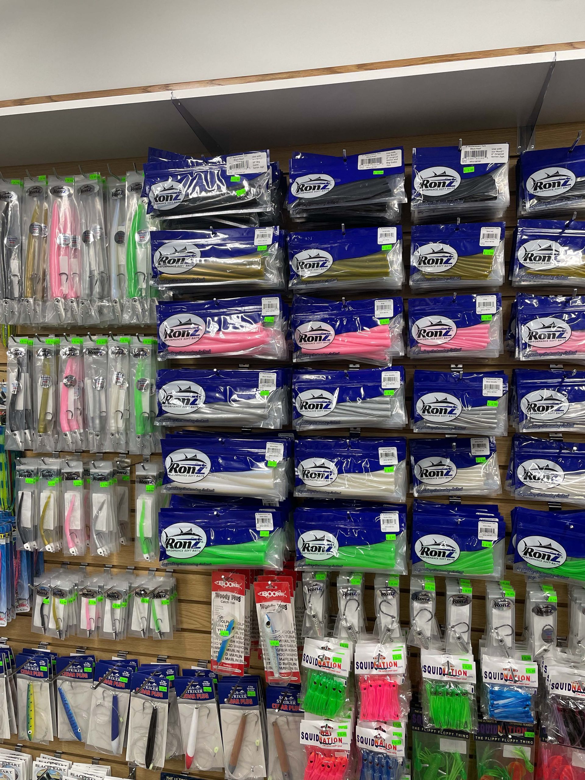 A shelf filled with lots of different types of fishing lures.
