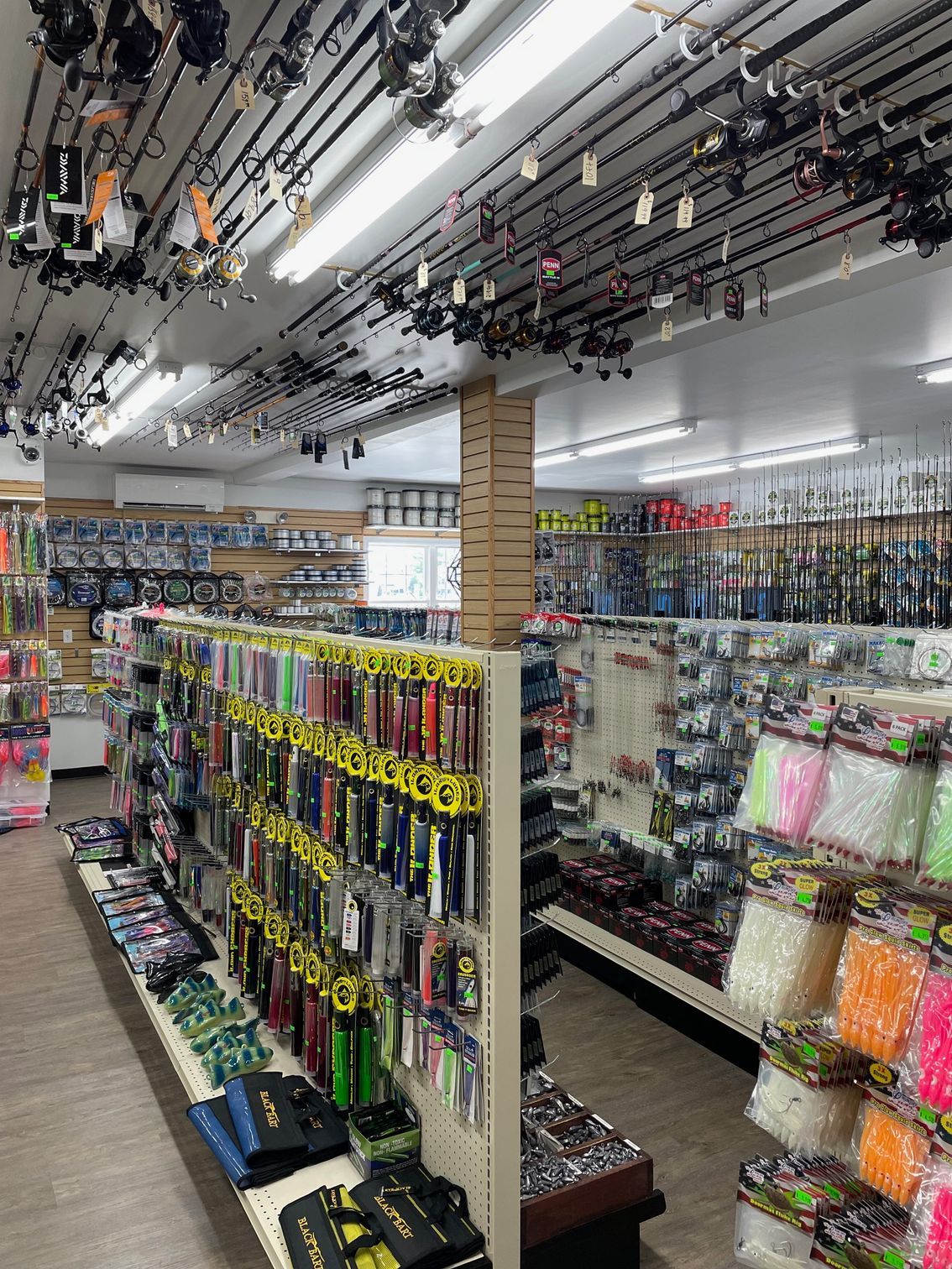 The inside of a fishing shop filled with lots of fishing gear.