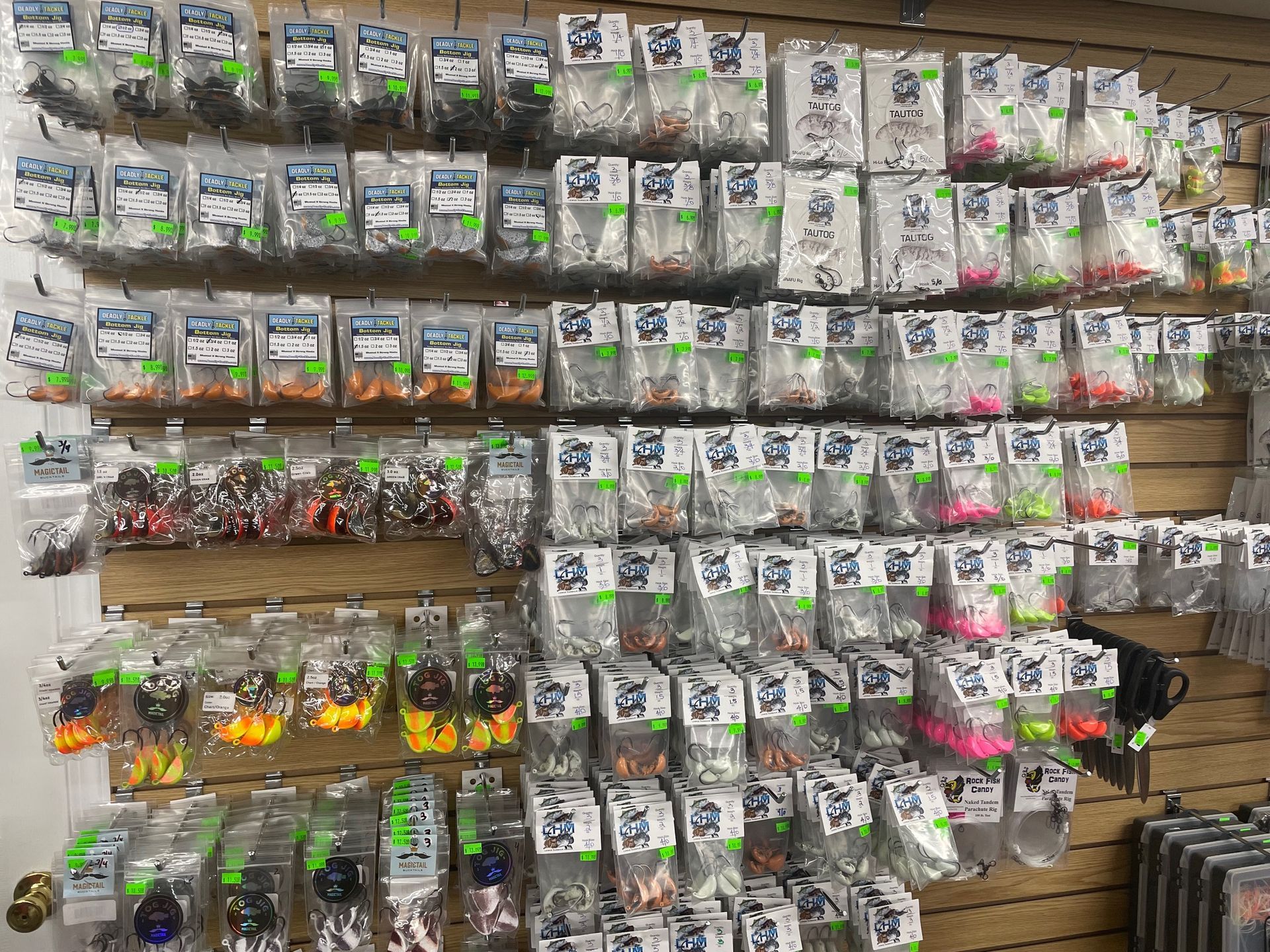 A wall filled with lots of fishing lures and hooks.