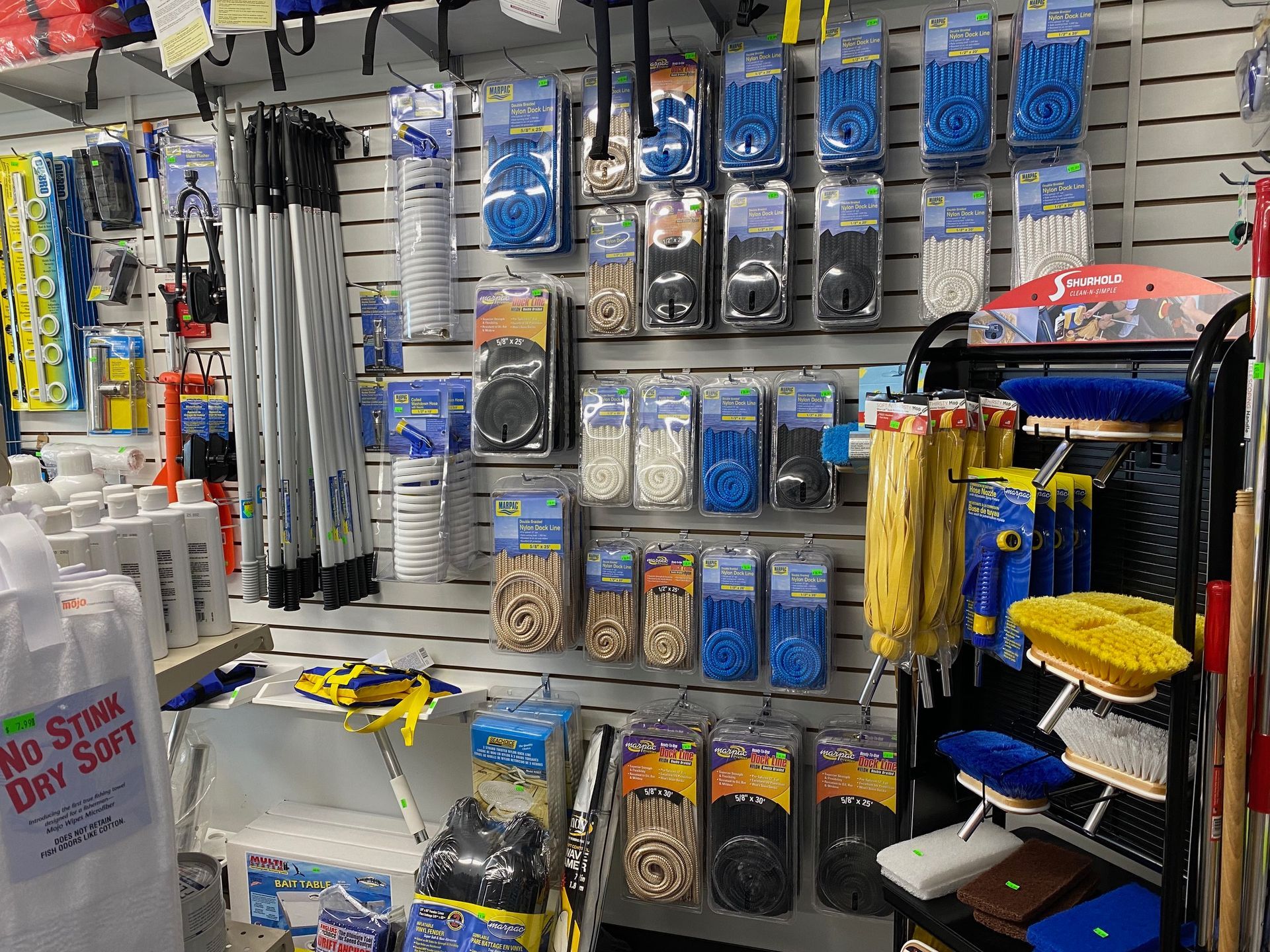 A variety of cleaning supplies are displayed on a wall in a store.