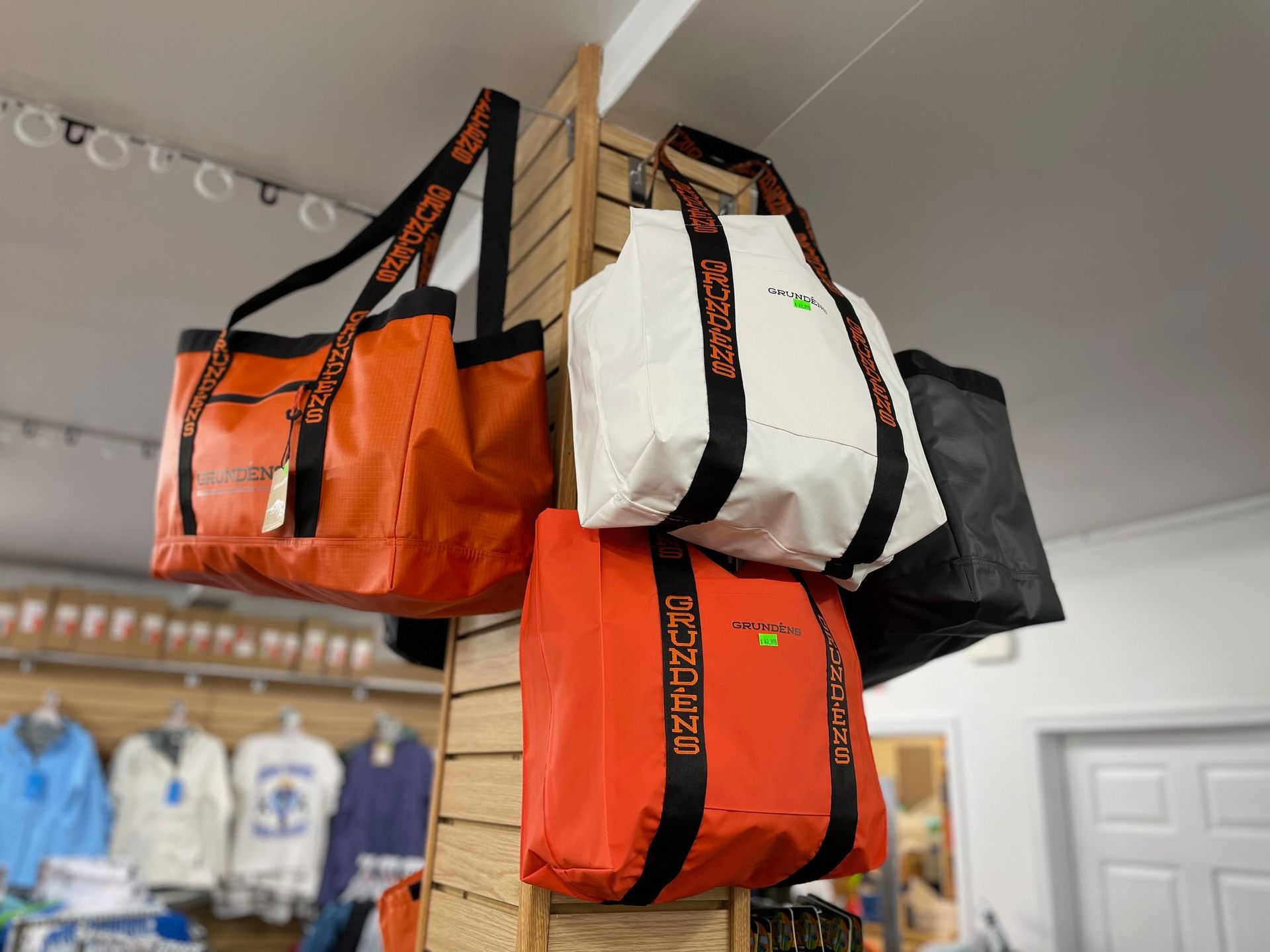 A bunch of bags are hanging on a wall in a store.