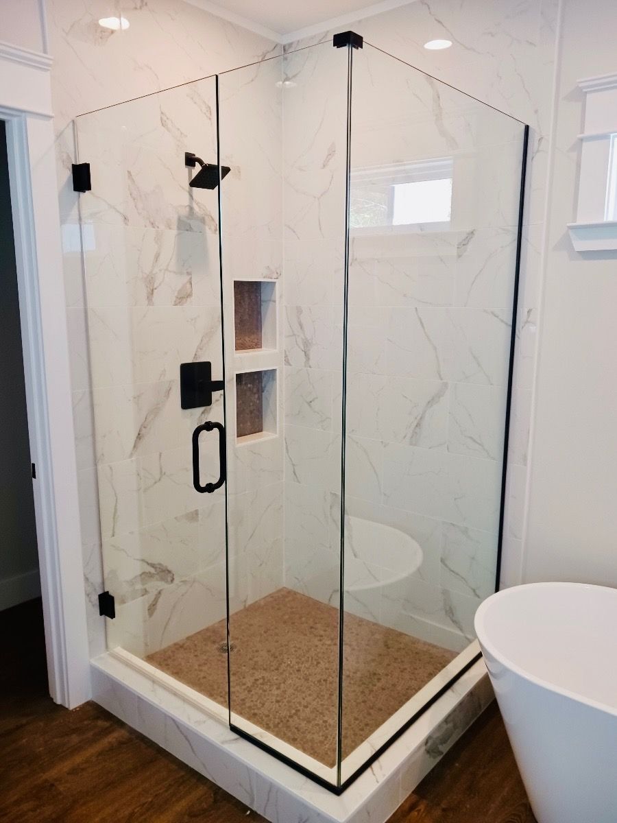 a bathroom with a walk in shower and a bathtub .